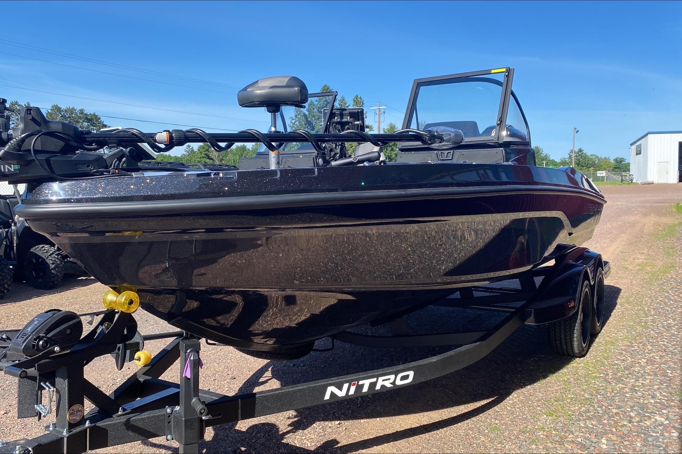 2026 Nitro ZV20 Pro boat on trailer, sleek black design under clear blue sky.