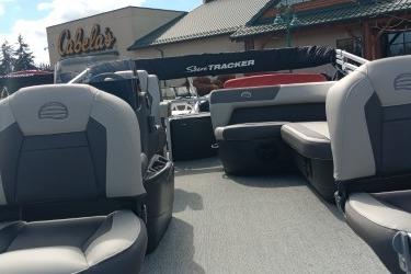 2026 Sun Tracker Bass Buggy 18 DLX pontoon boat with seating, displayed at Cabela's.