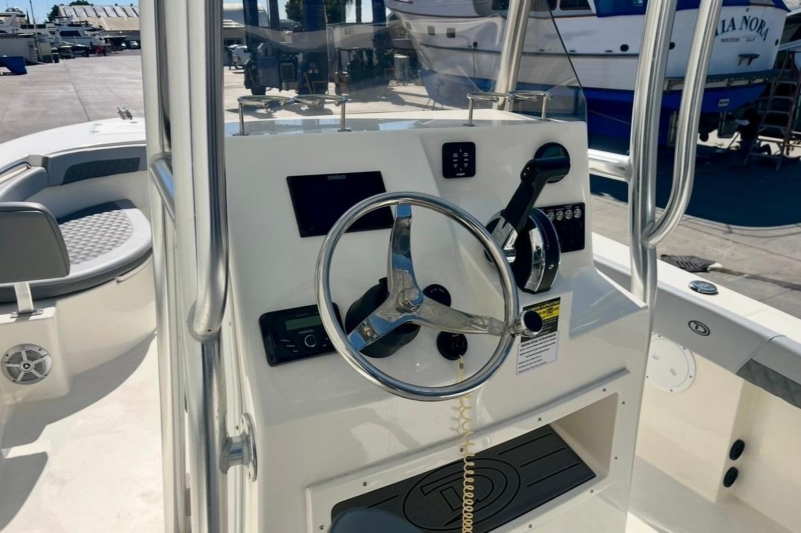 2025 Defiance Catalina 240 boat cockpit with steering wheel and control panel.
