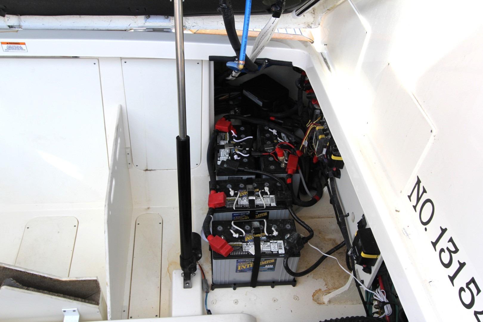 2021 Sea Ray Sundancer 320 Outboard battery compartment with multiple batteries and wiring.