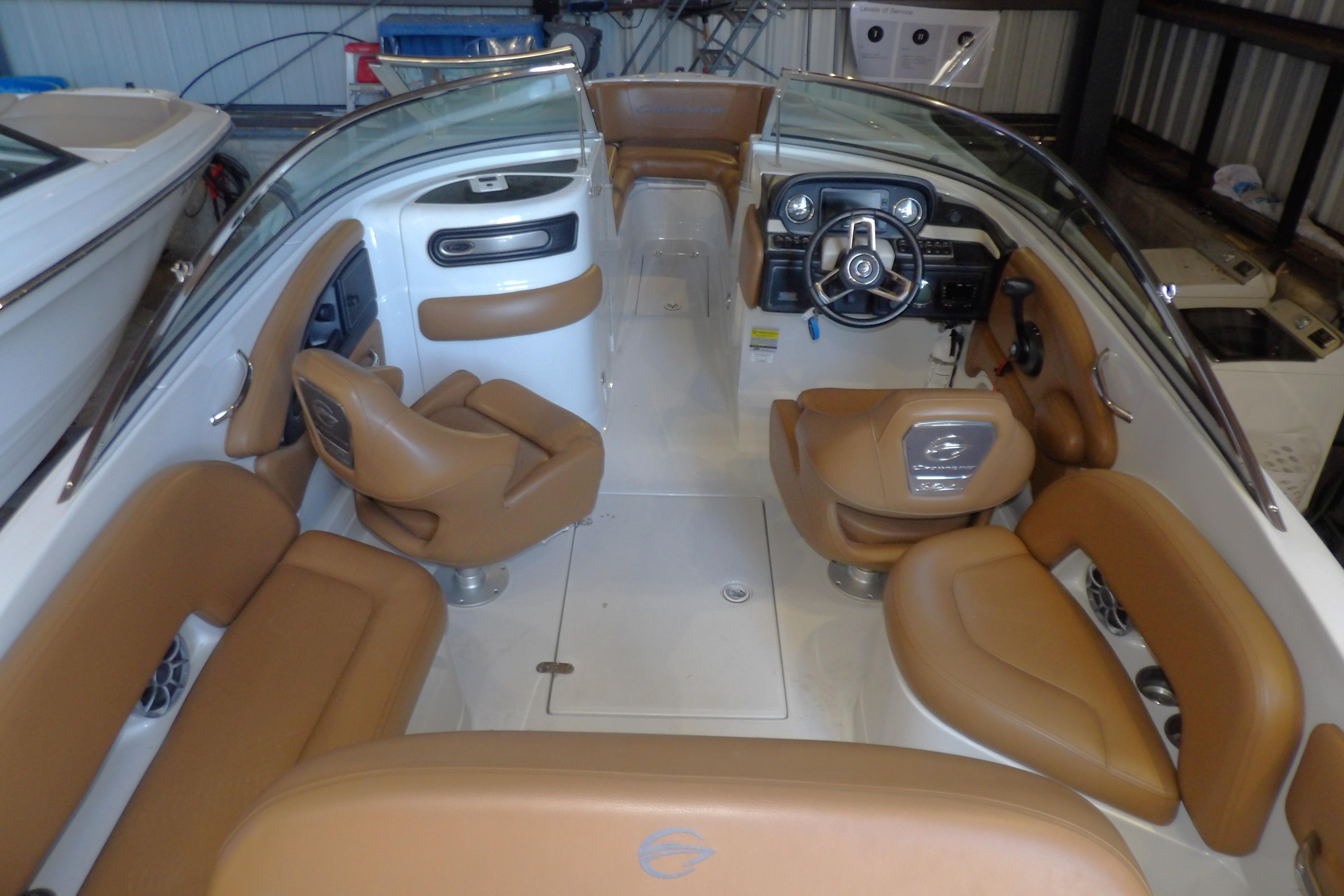 2023 Crownline 250 XSS boat interior with tan seating and modern dashboard.