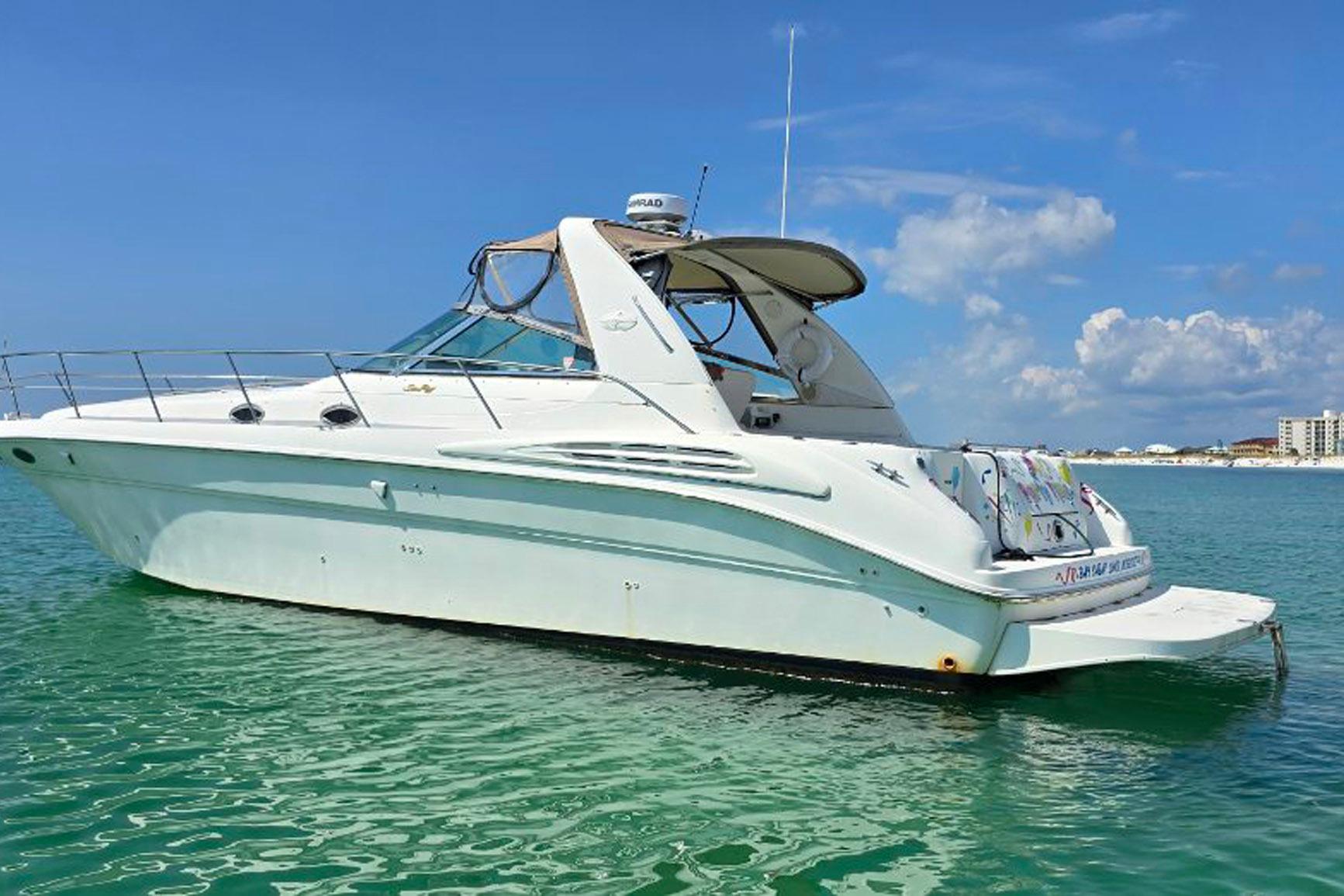 1998 Sea Ray Sundancer 400 yacht on clear blue water under a sunny sky.