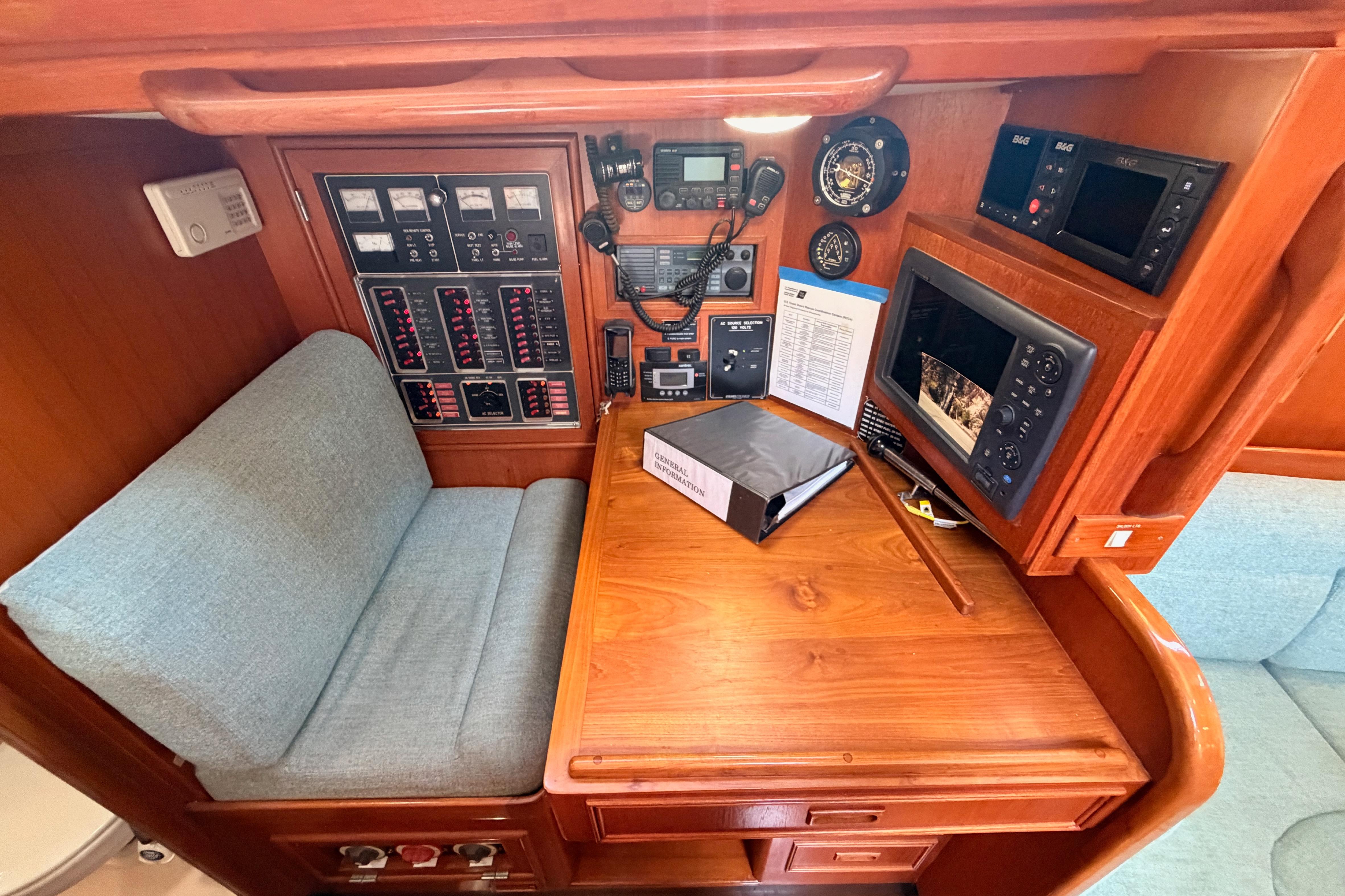 Navigation station of a 1991 Hylas 51 yacht with control panels and seating.
