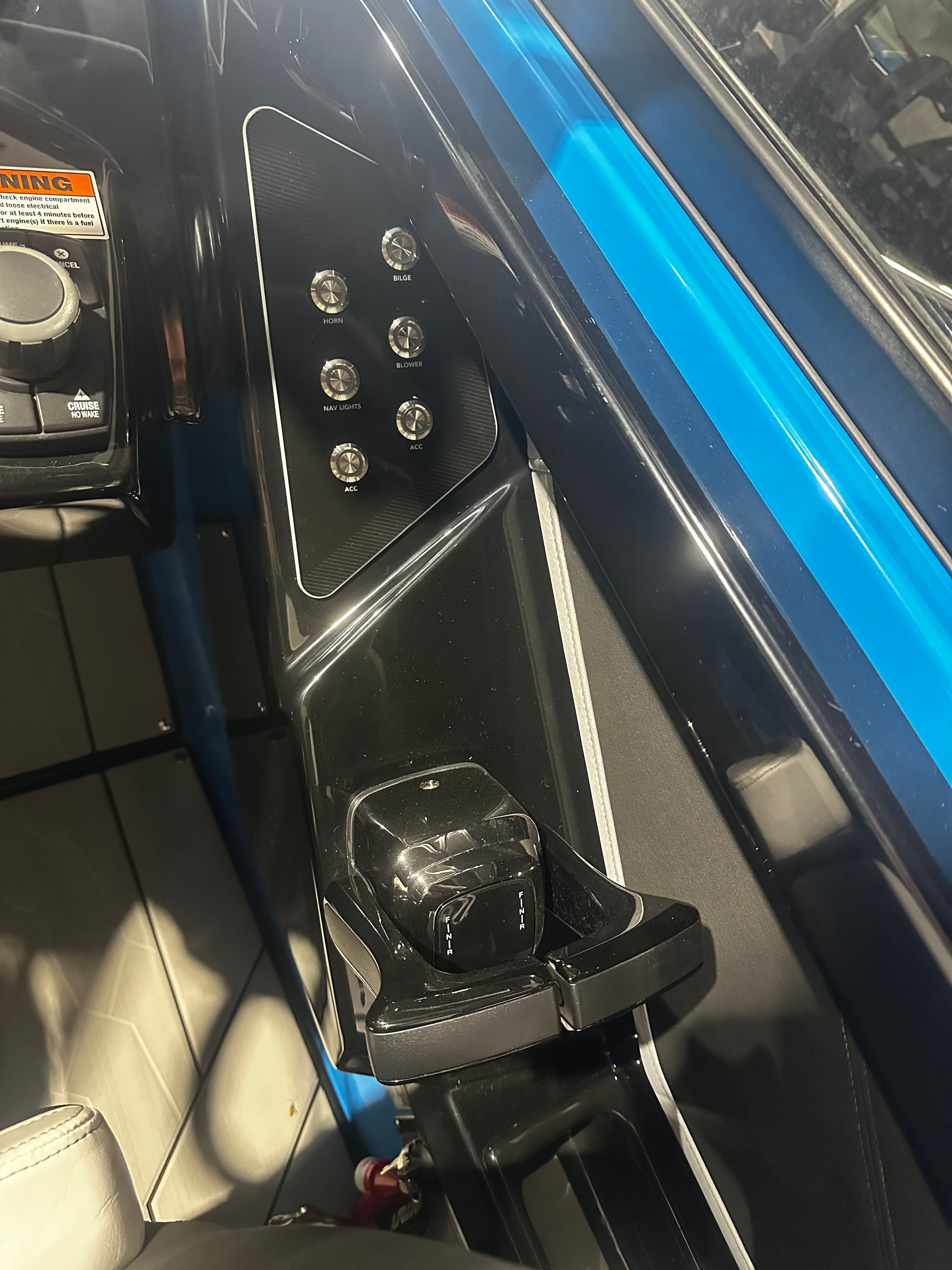 Control panel of 2023 Yamaha Boats 255XD with switches and throttle lever.