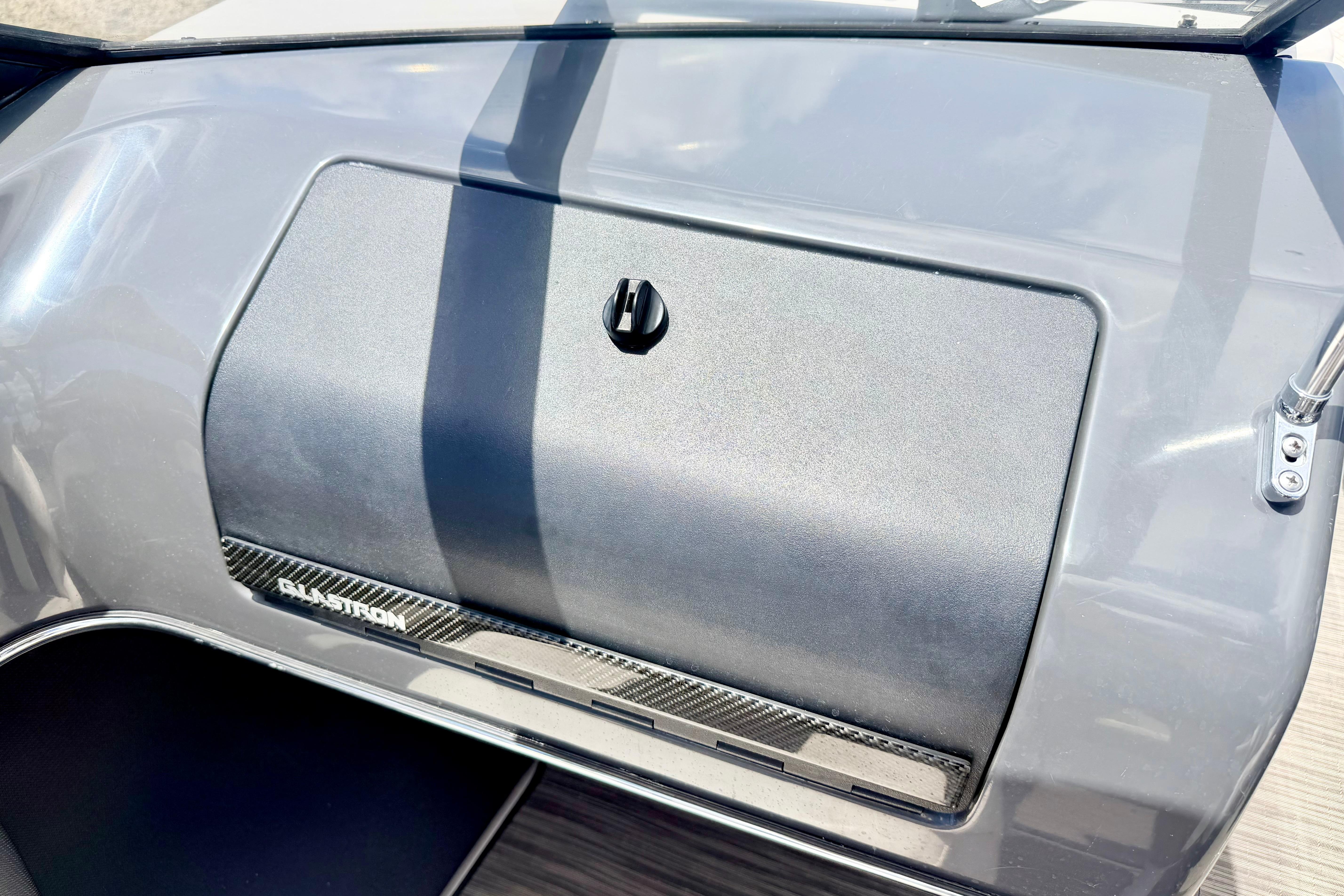 Dashboard of a 2018 Glastron GT 185 boat with storage compartment.