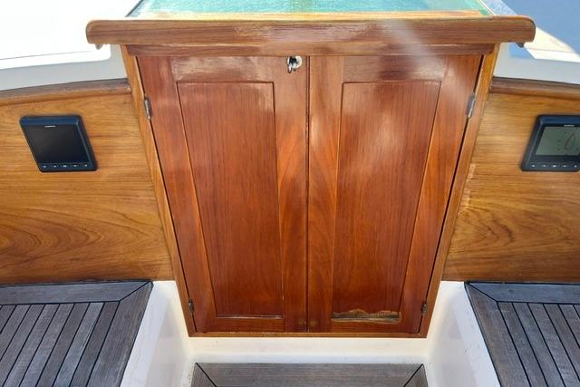 Wooden cabin door on a 2006 Morris 36 boat, featuring elegant teak finish.
