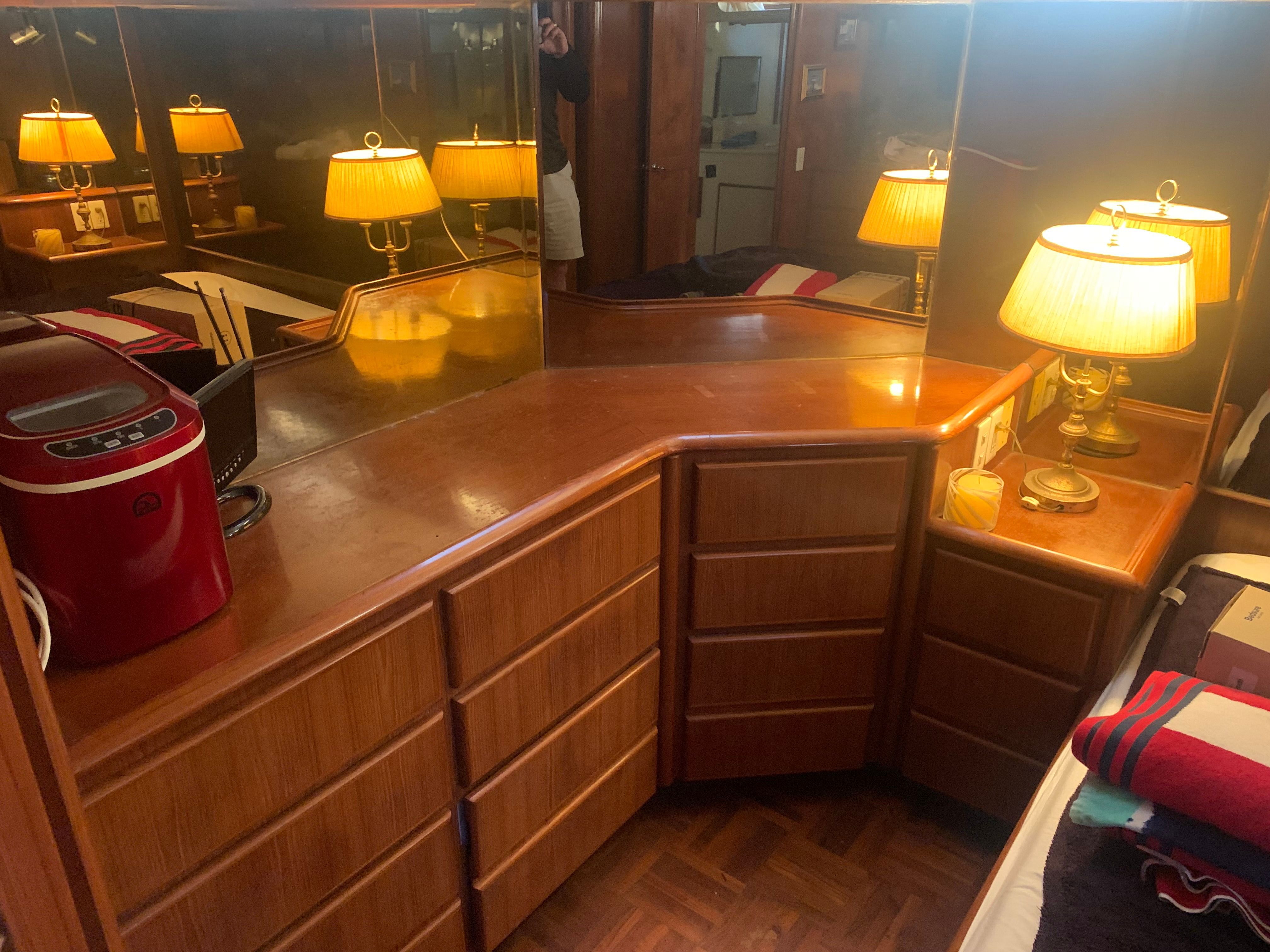 Interior of a yacht with wooden cabinets and table lamps.