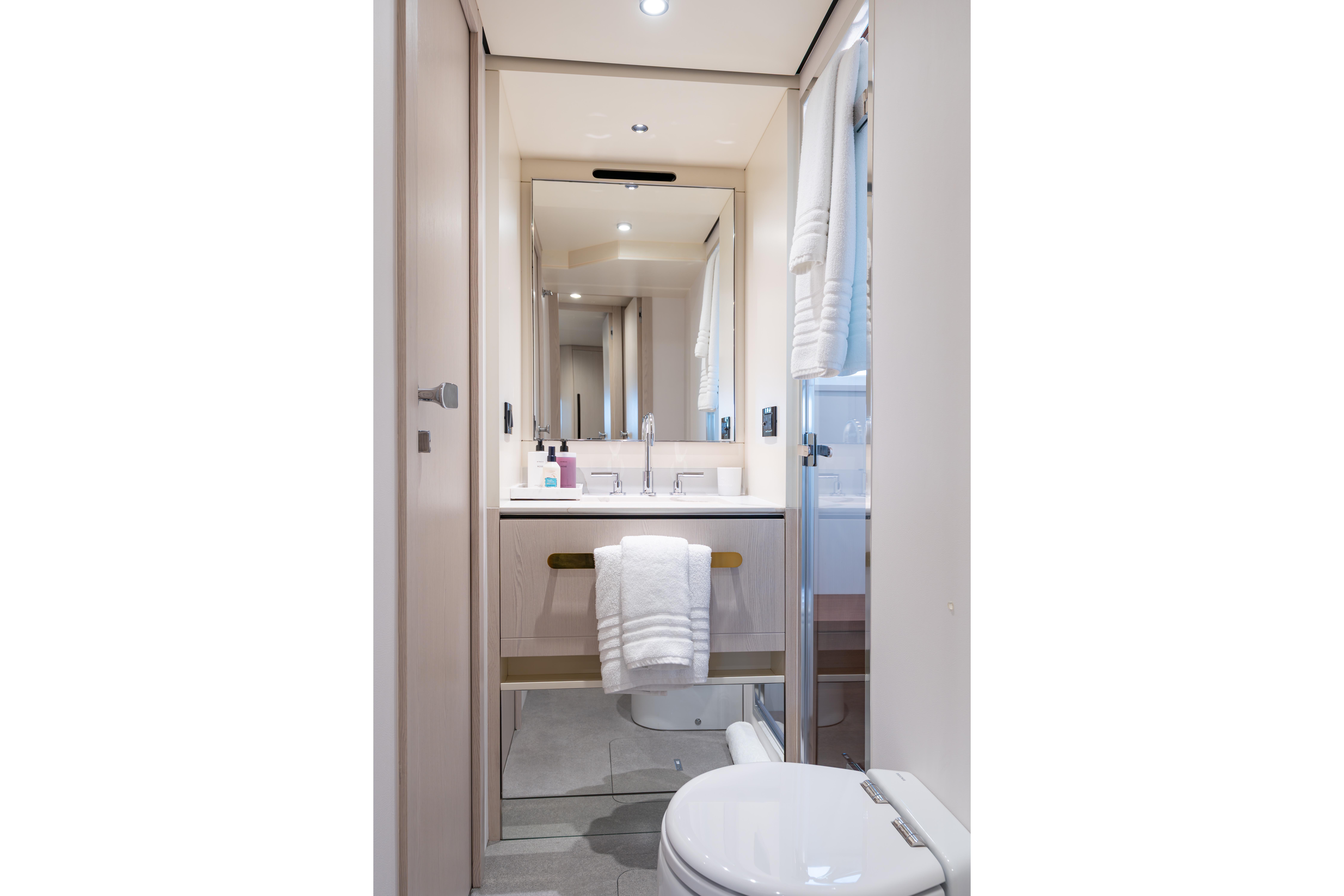 Luxurious bathroom in 2022 Azimut 78 yacht, featuring modern fixtures and elegant design.