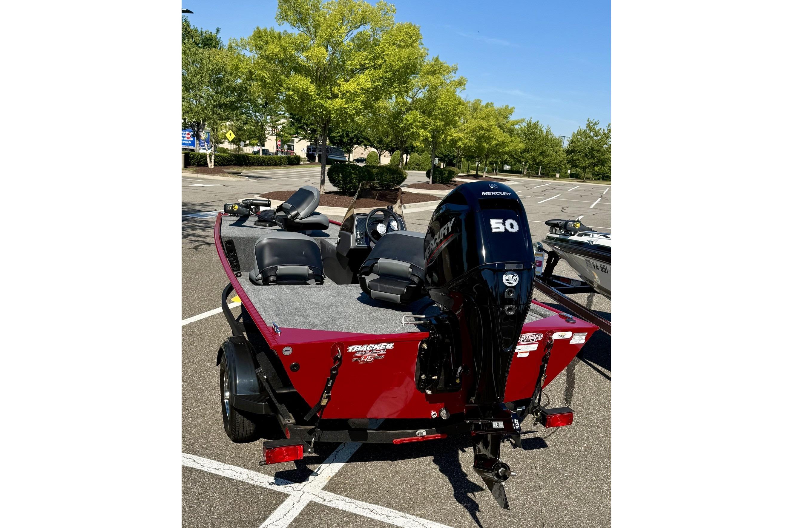 2023 Tracker Bass Tracker Classic XL boat with Mercury 50 engine in a parking lot.