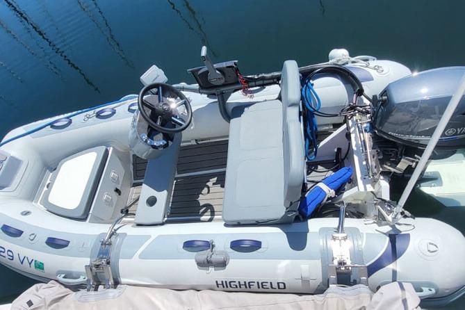 Highfield inflatable boat docked beside a 2008 Carver 43 Super Sport yacht.