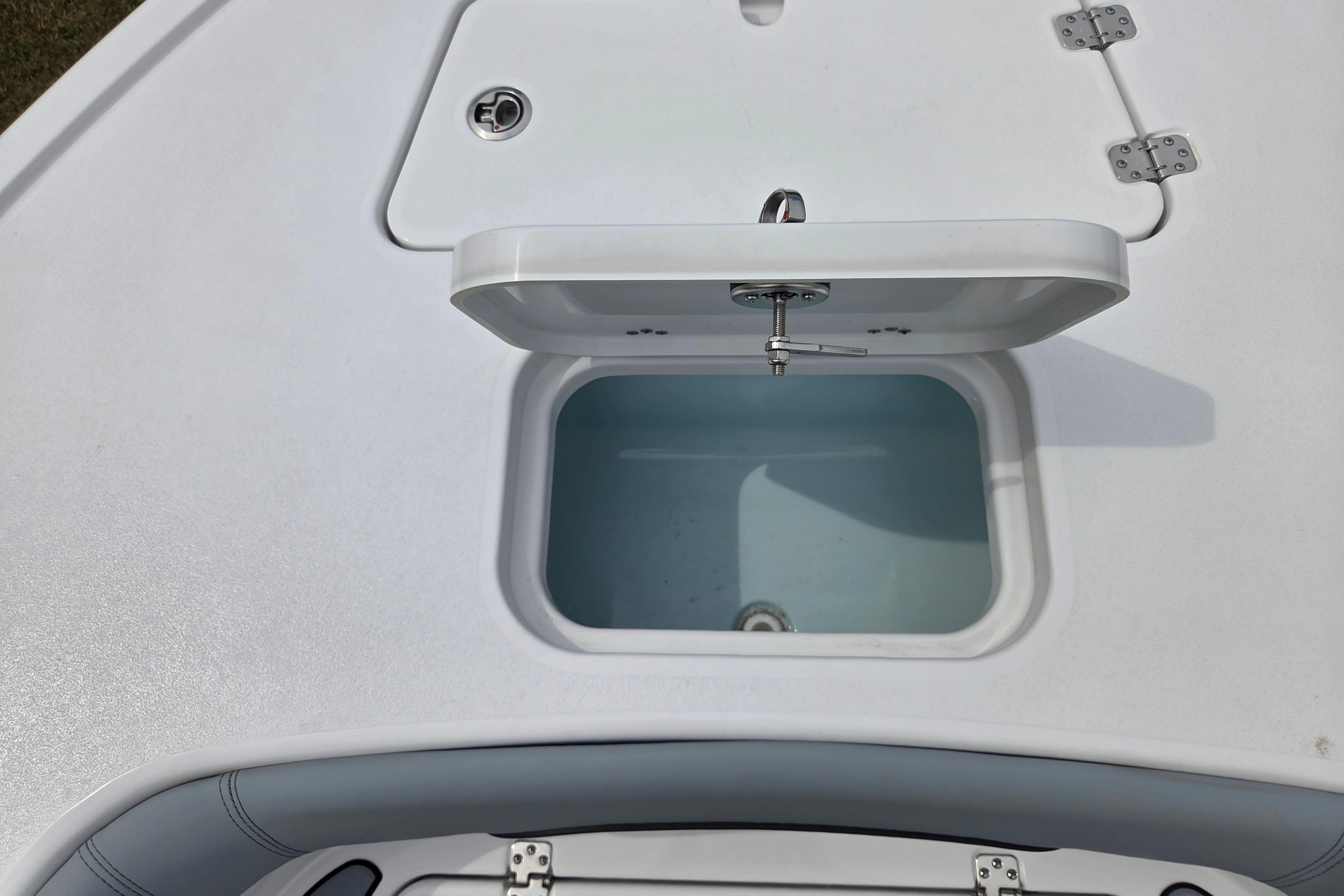 Open storage compartment on 2026 Sportsman Masters 247OE Bay Boat deck.