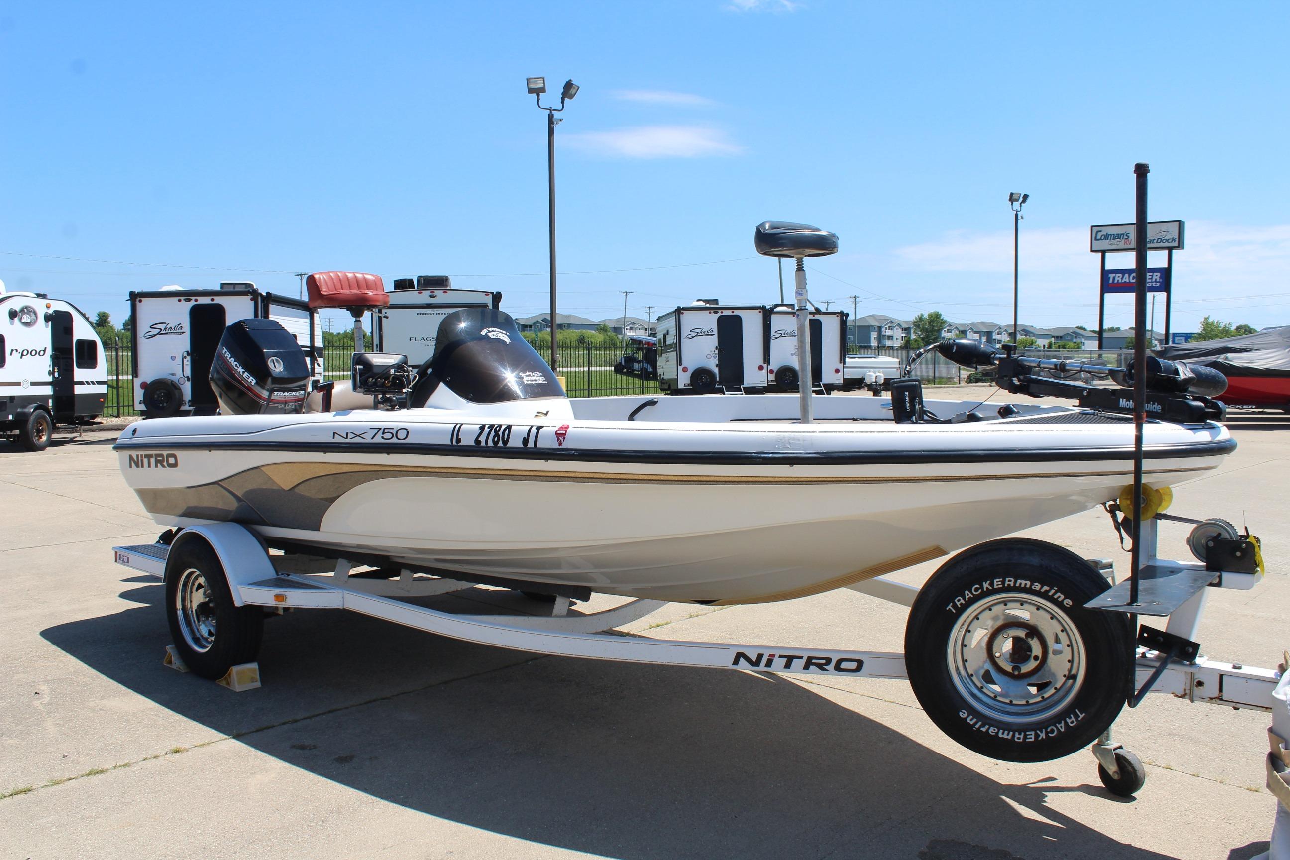 2003 Nitro NX 750 SC boat on trailer, parked outdoors under clear sky.