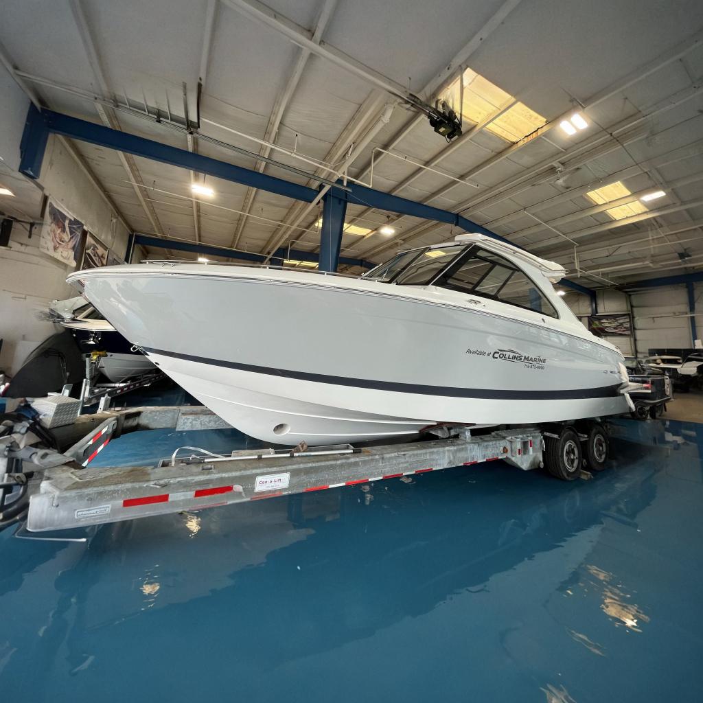 2023 Regal LX36 boat on a trailer in a showroom.