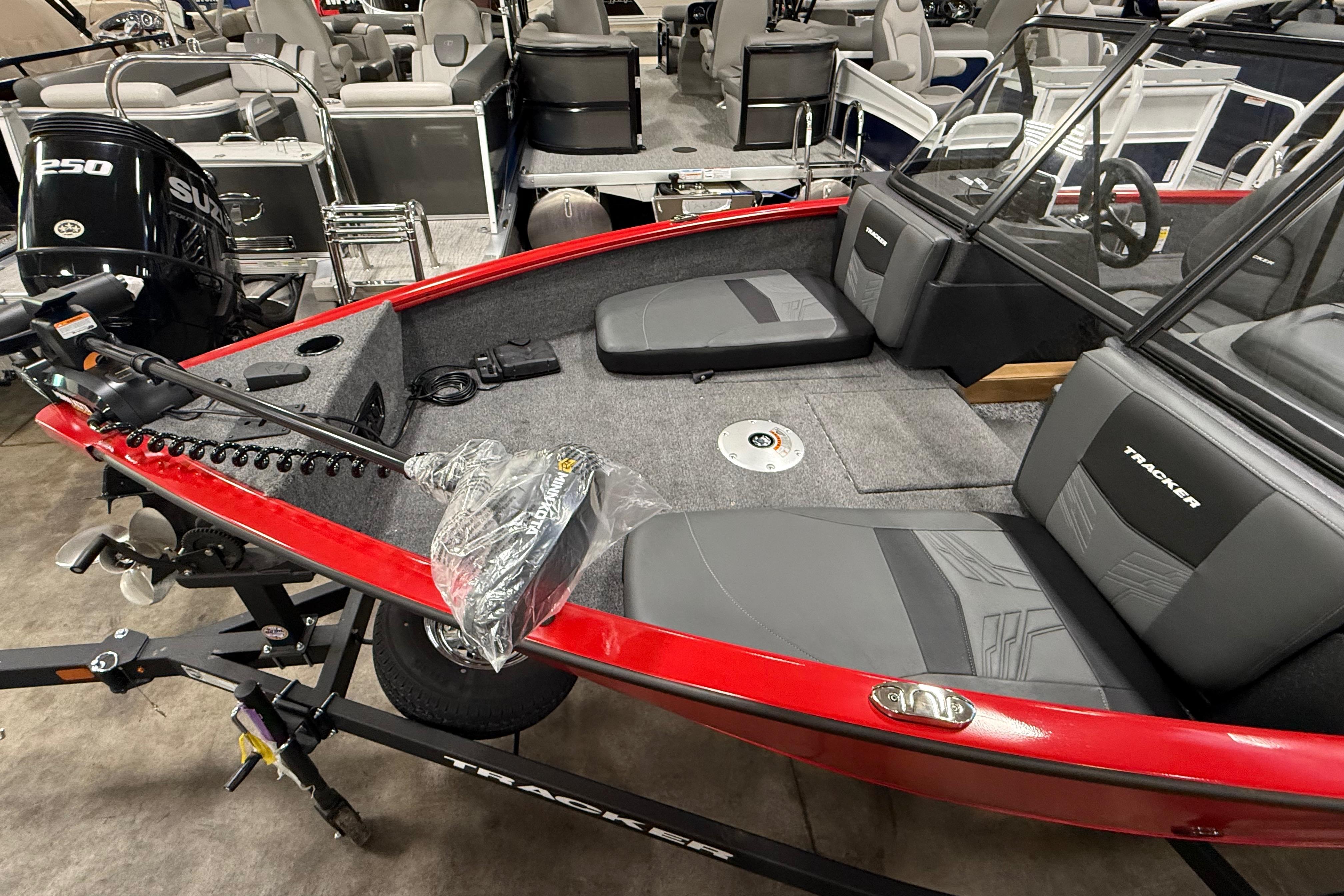 2026 Tracker Pro Guide V-175 Combo boat with red exterior and gray interior seating.
