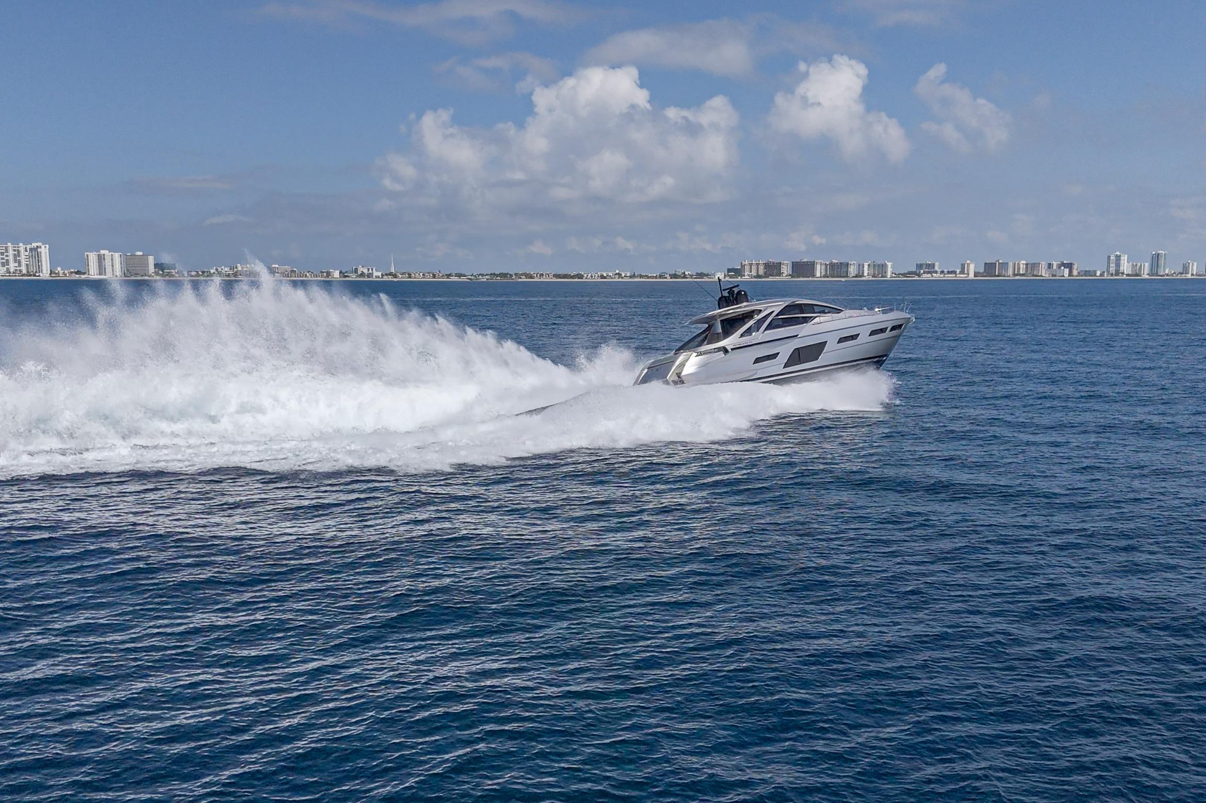 2024 Pershing 7X yacht cruising swiftly on open ocean under clear skies.