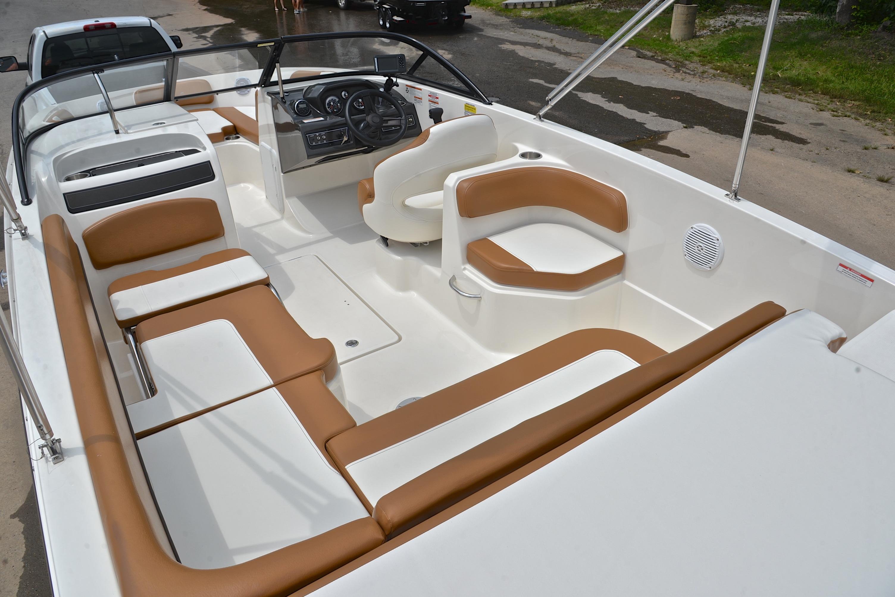 2019 Bayliner VR6 Bowrider OB interior with tan and white seating, steering wheel, and dashboard.