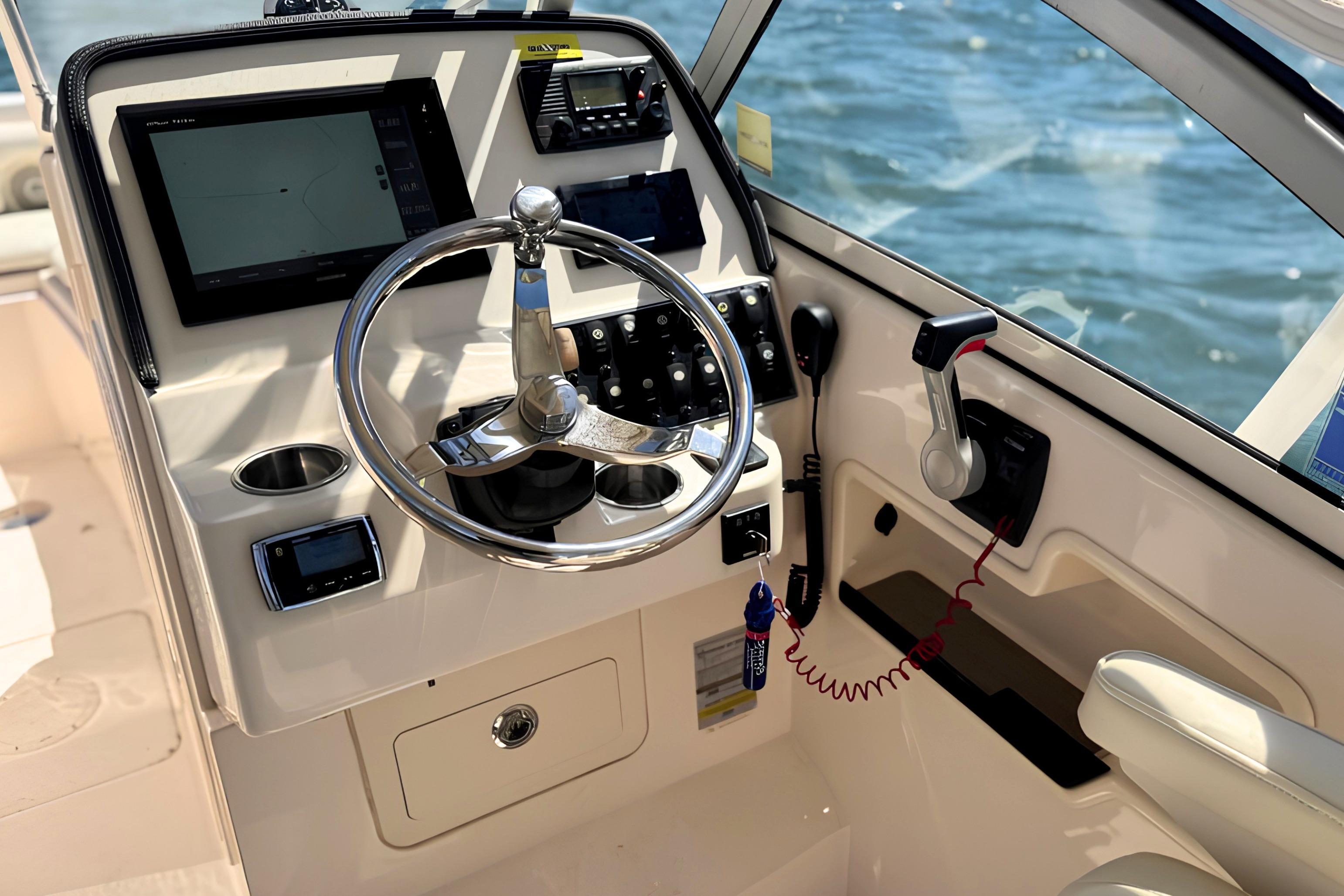 2017 Grady-White Freedom 235 boat helm with steering wheel and navigation controls.