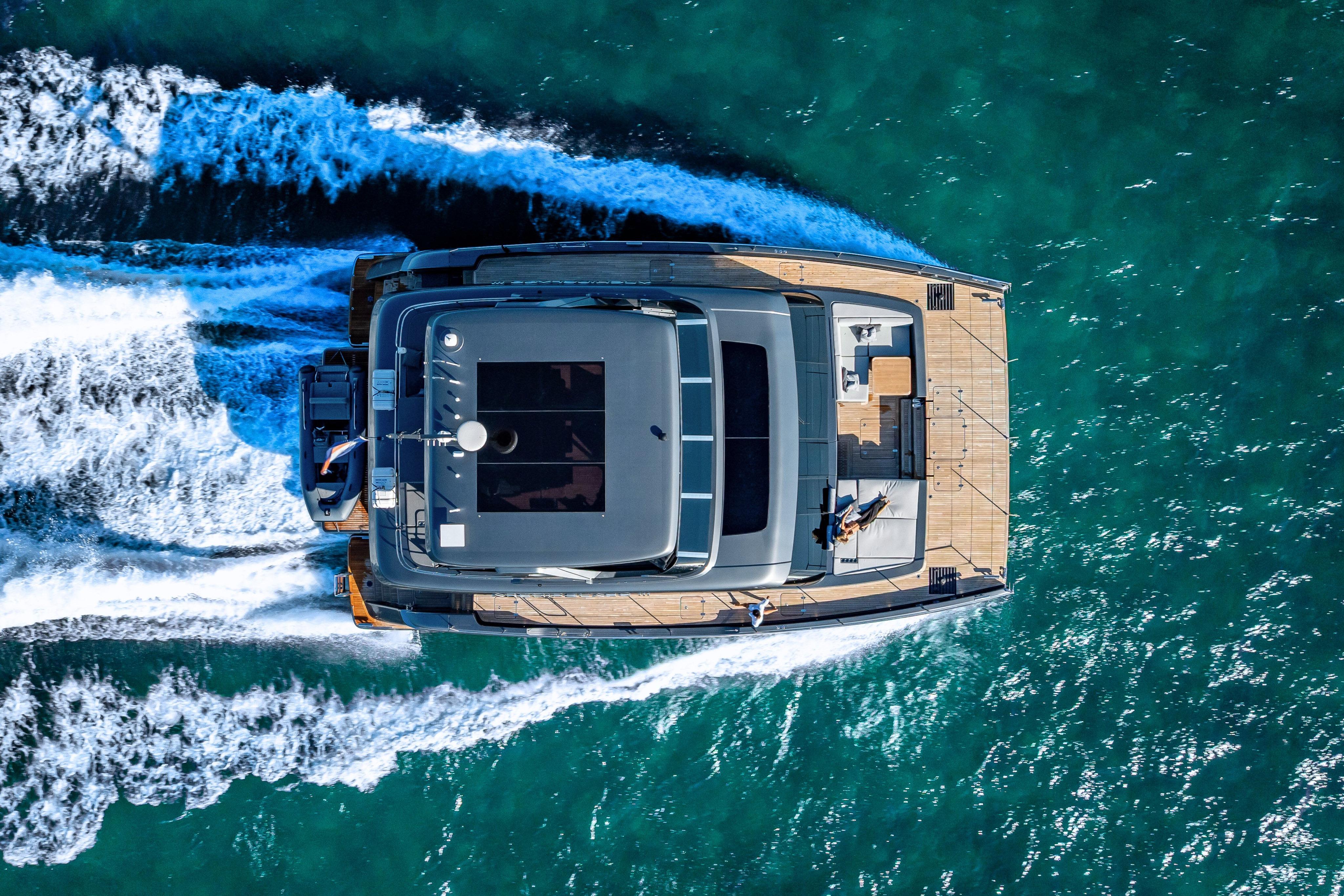 Aerial view of 2026 Sunreef 60 Power yacht cruising on turquoise waters.