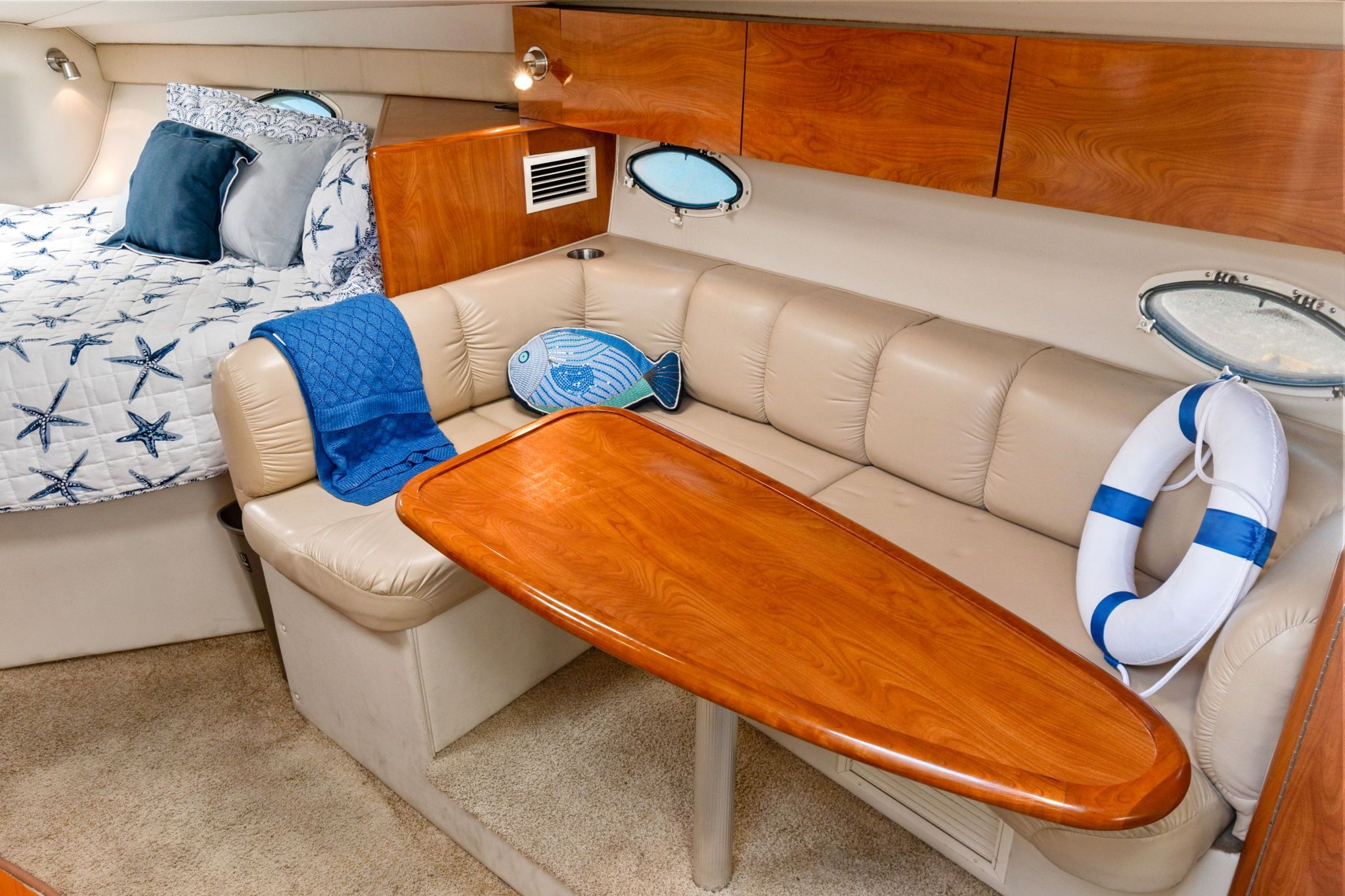 Interior of the 2007 Larson Cabrio 330 with cozy seating area and sleeping space.
