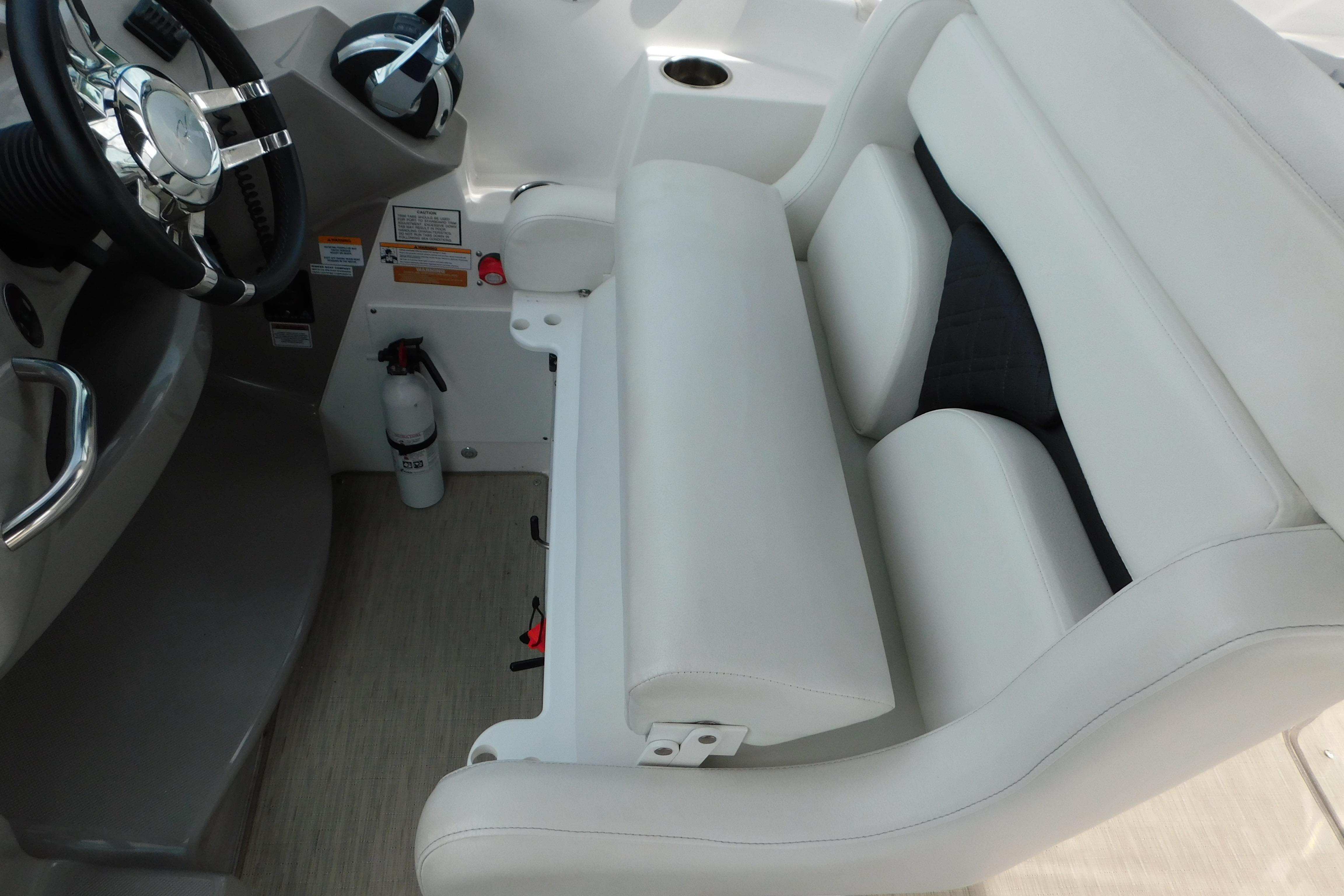 2017 Rinker EX 320 boat interior with white seating and steering wheel.