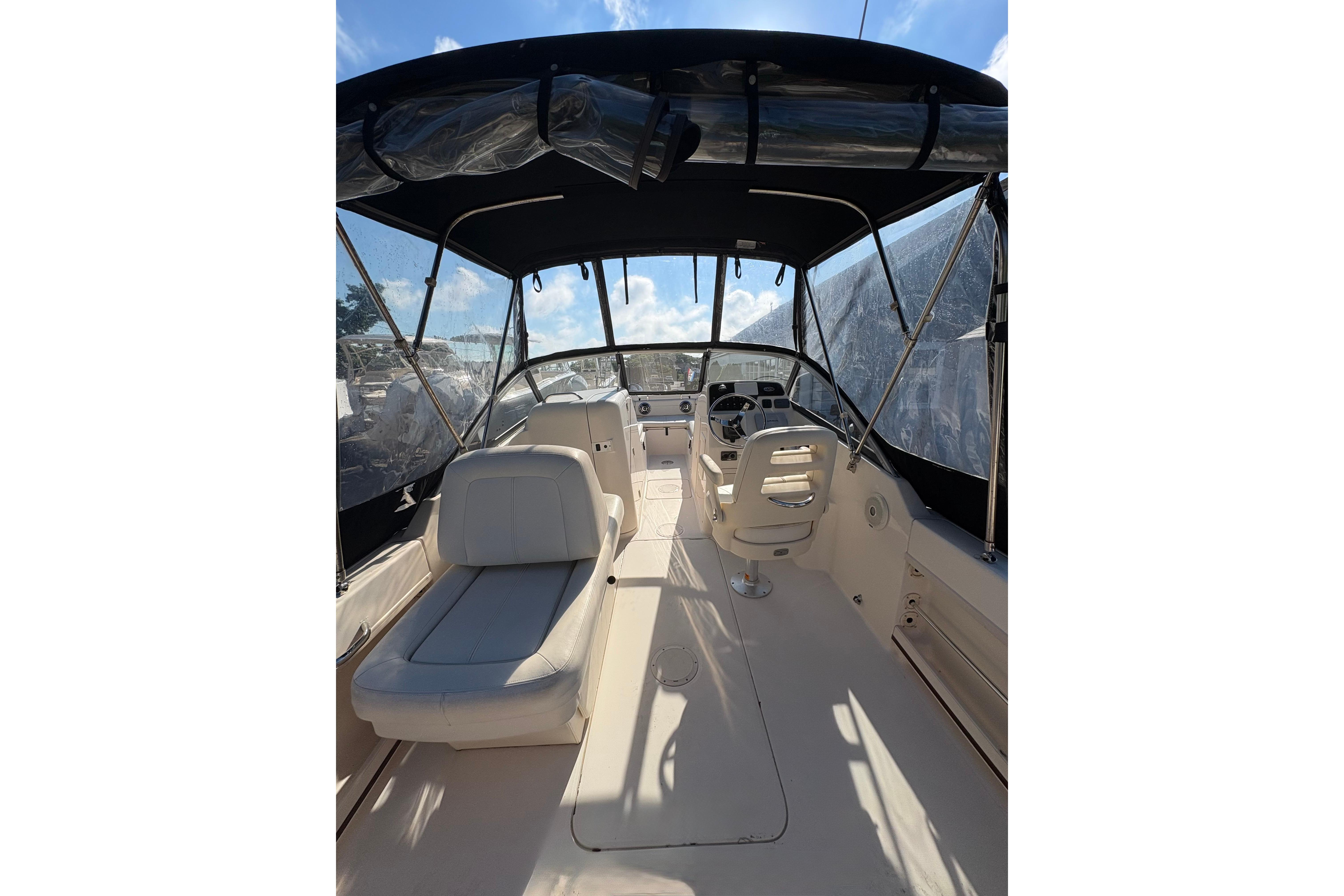 2015 Grady-White Freedom 225 boat interior with seating and helm under canopy.