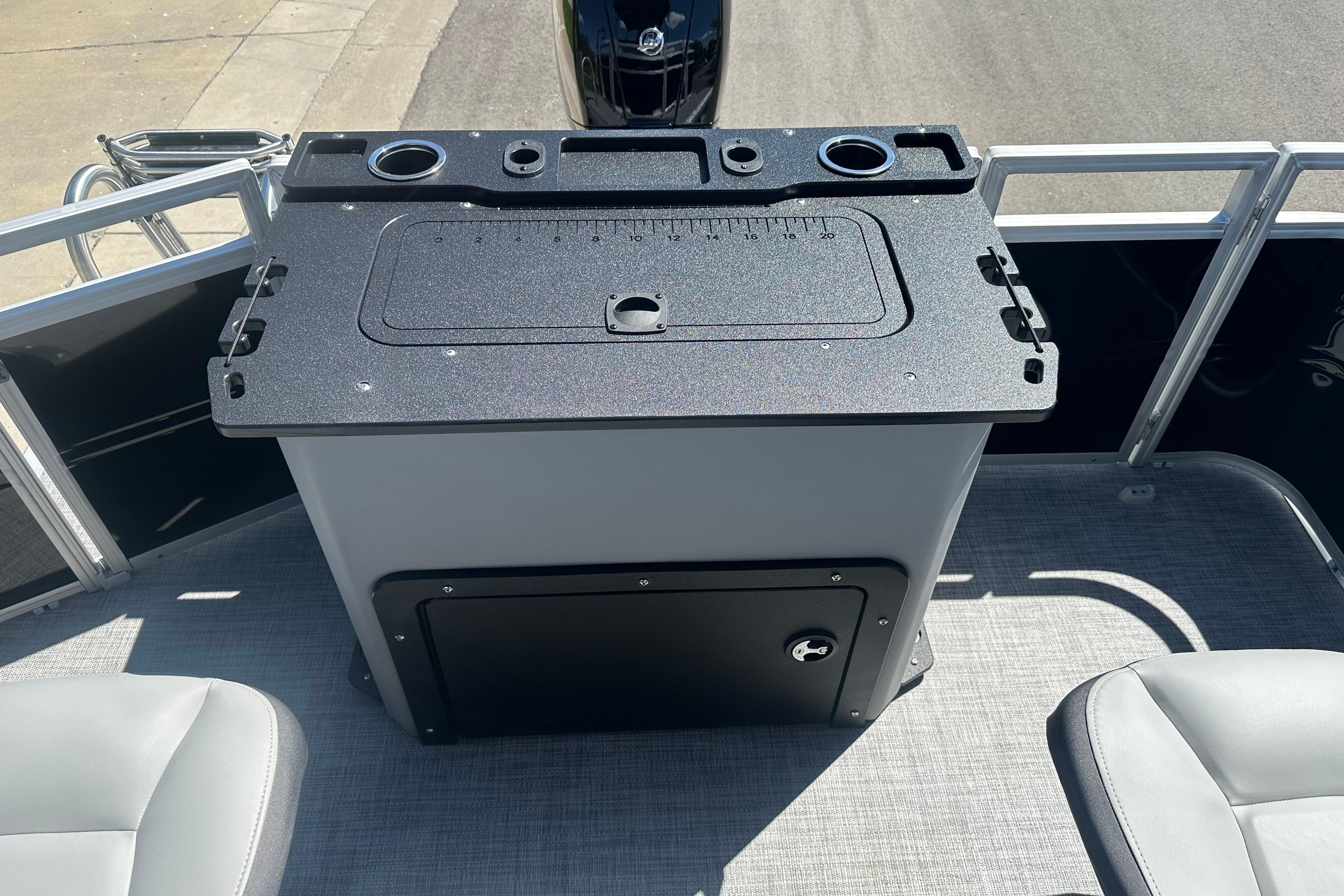 2026 Sun Tracker SportFish 22 DLX boat interior with fishing station and seating.