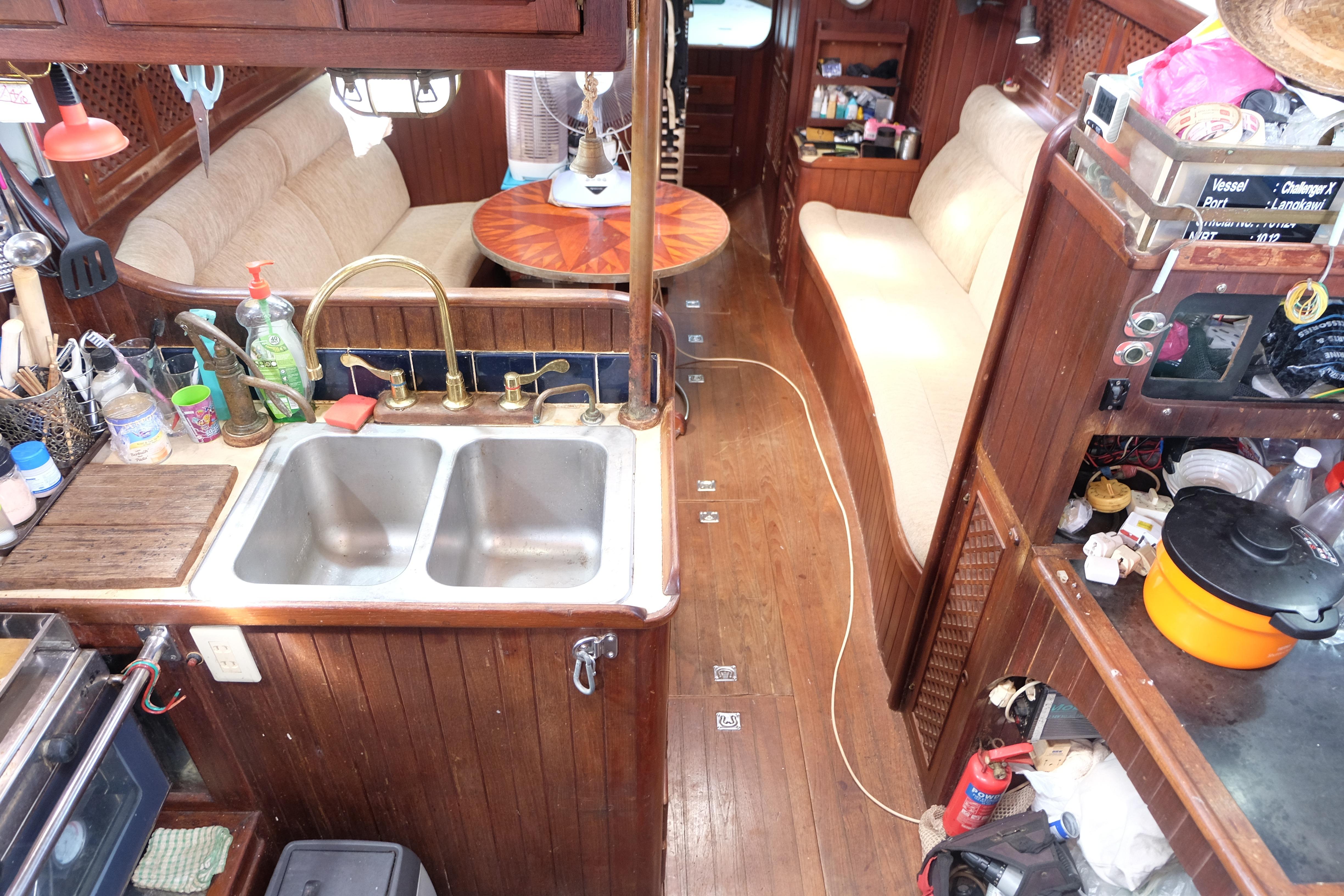Interior of a 1979 Westwind 35 sailboat with a cozy kitchen and seating area.