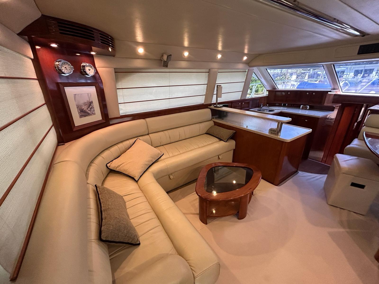 Interior of 2009 Riviera 47 Enclosed Flybridge with elegant leather seating.