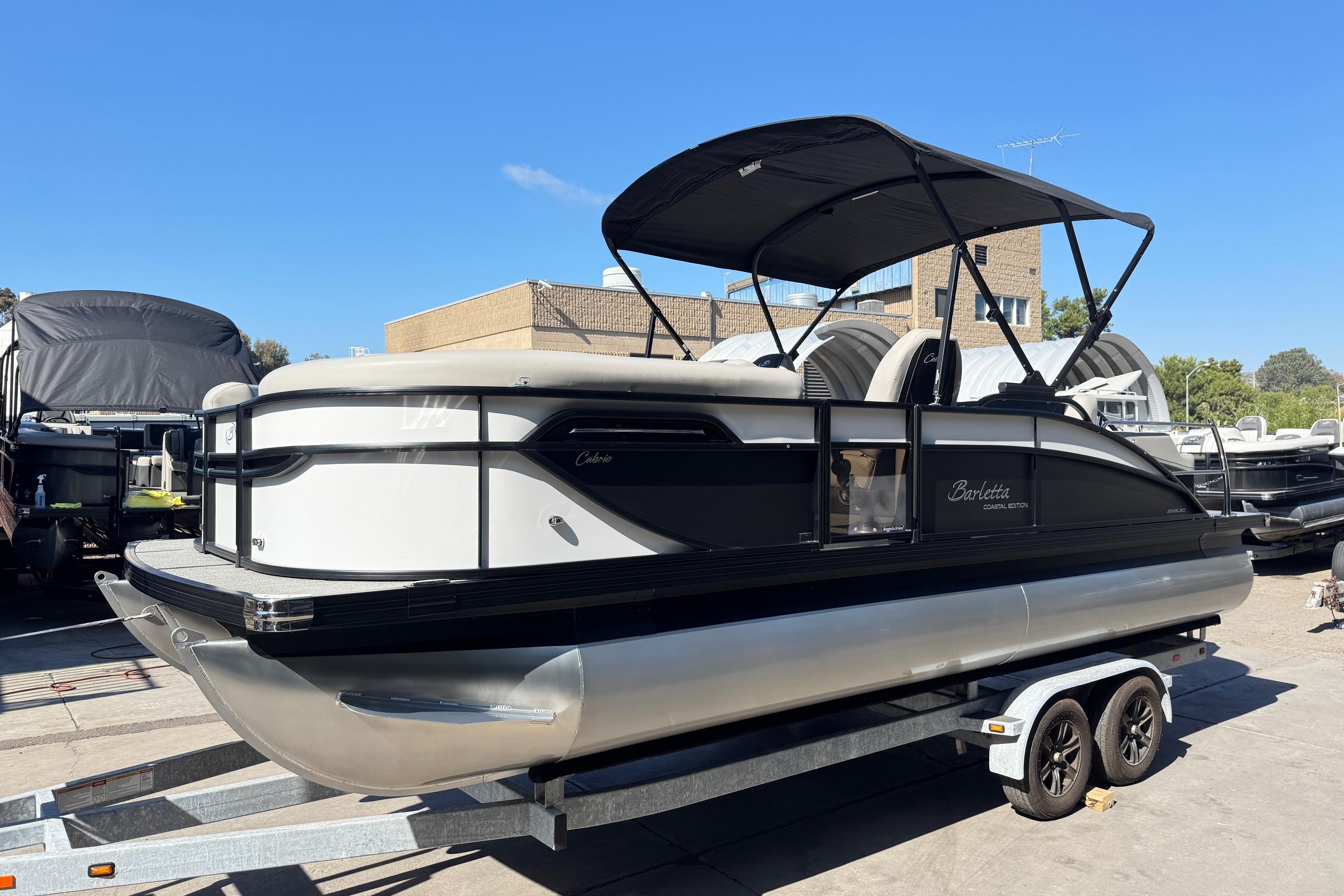 2026 Barletta Cabrio 22UC pontoon boat on trailer, outdoor display.
