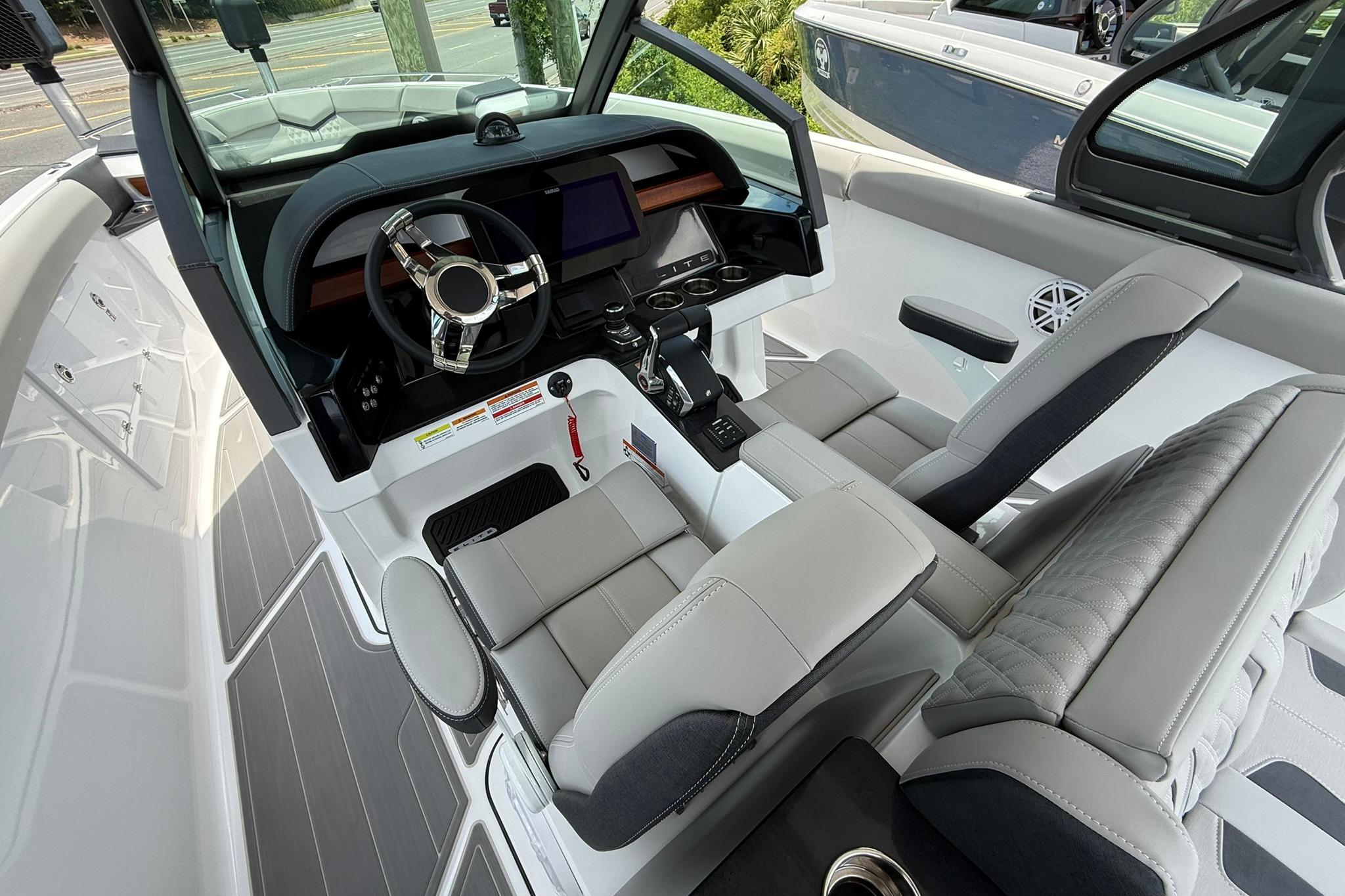 Interior of 2027 Monterey Elite 30 OB boat with modern steering and seating.