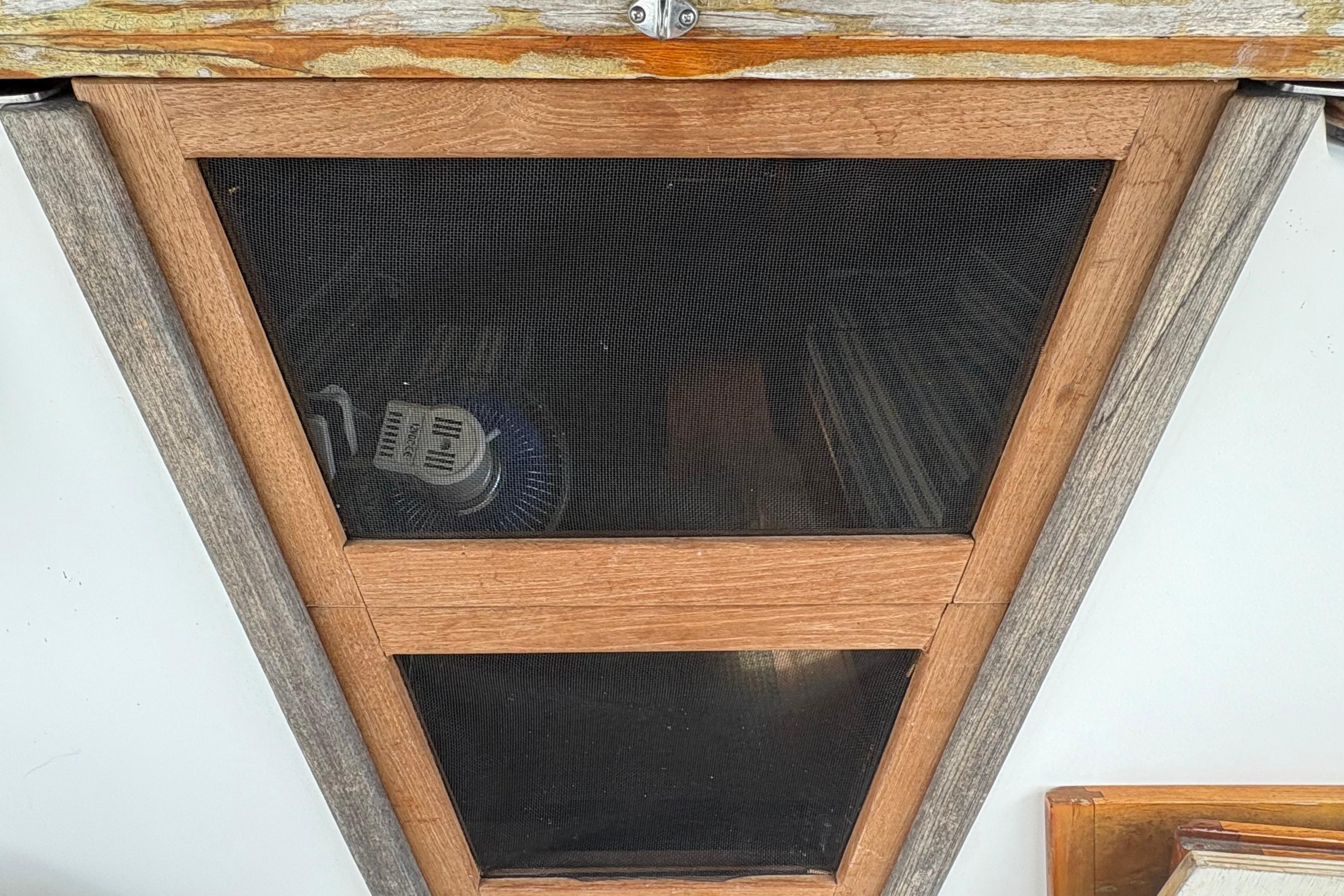 Wooden framed hatch with mesh screen on a 1981 Sabre 31 boat.