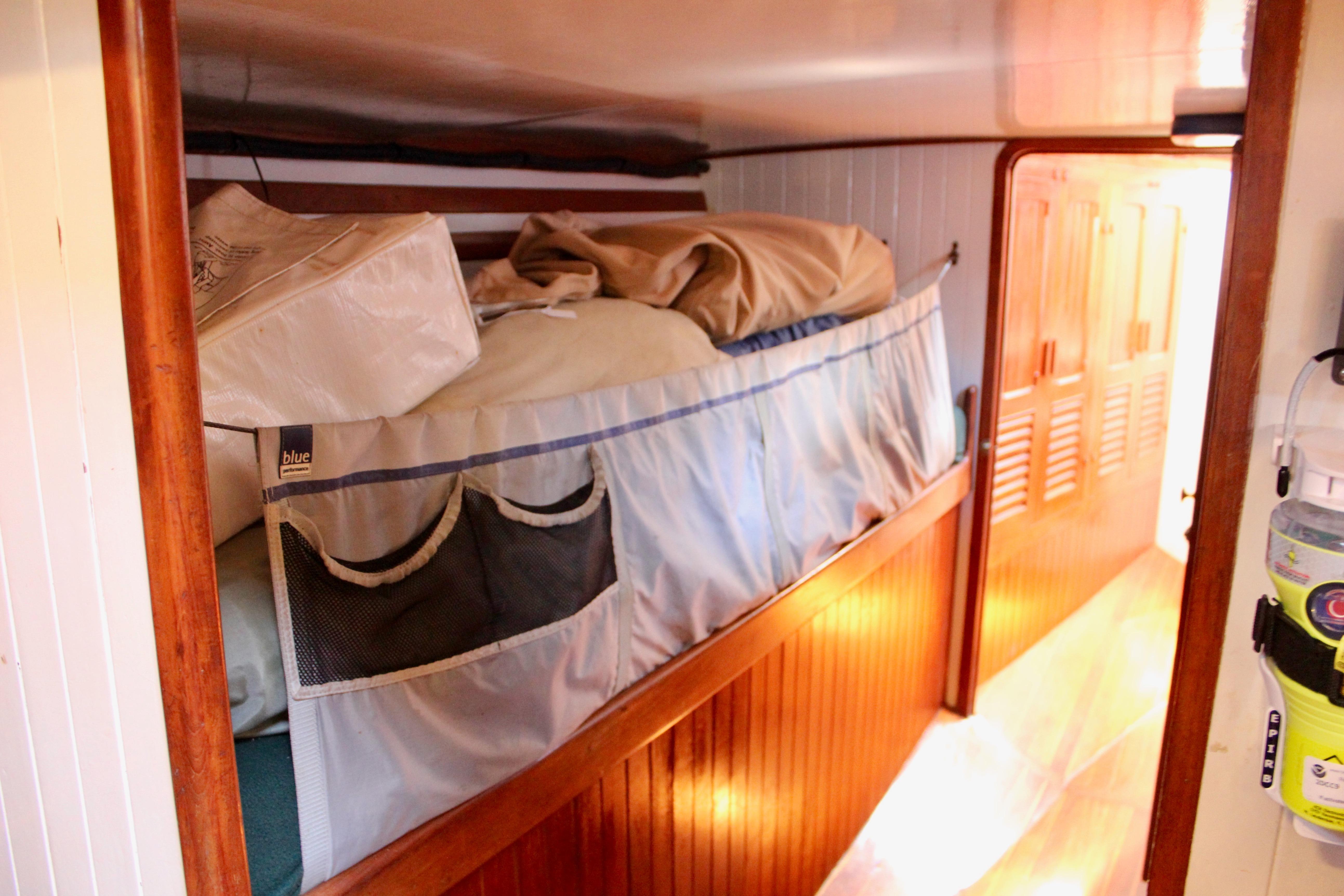 Interior of 1981 Kelly Peterson 46 sailboat with bunk bed and storage.