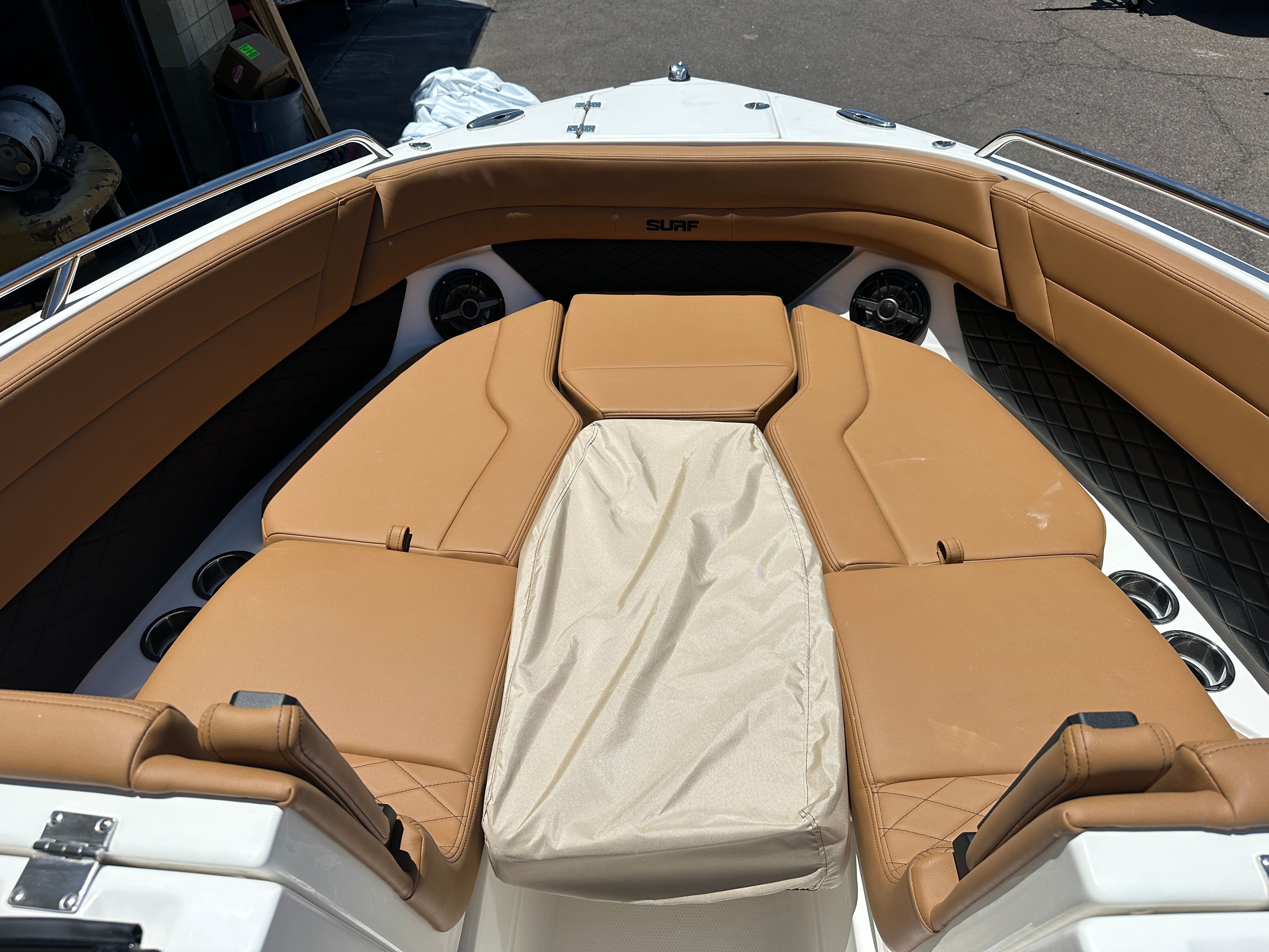 The image shows the bow area of a Chaparral 26 Surf boat with beige upholstery.
