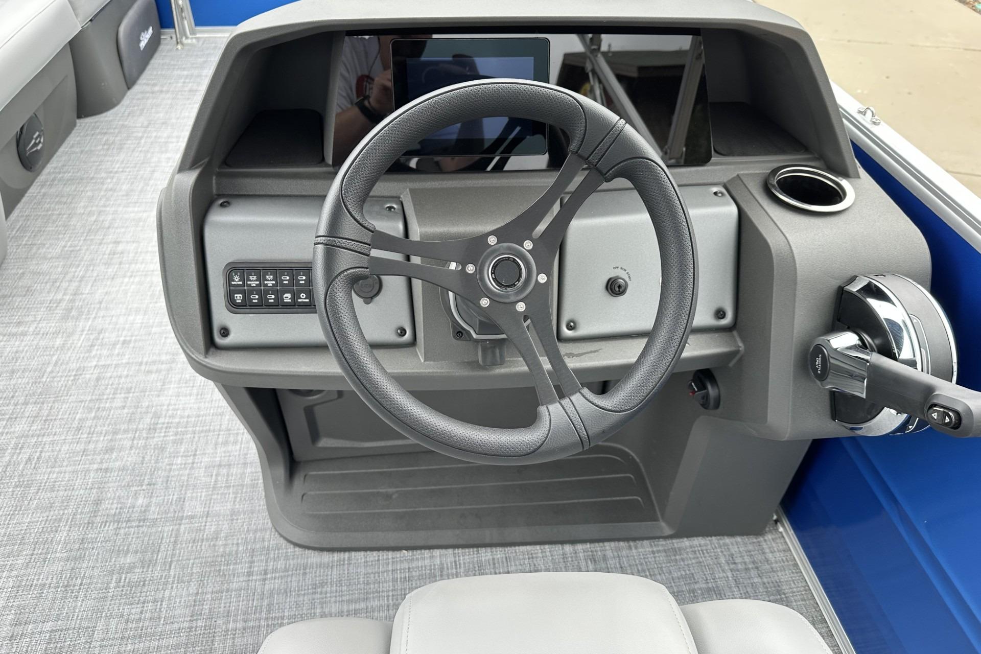 Steering console of 2026 Sun Tracker Party Barge 20 DLX with modern controls.