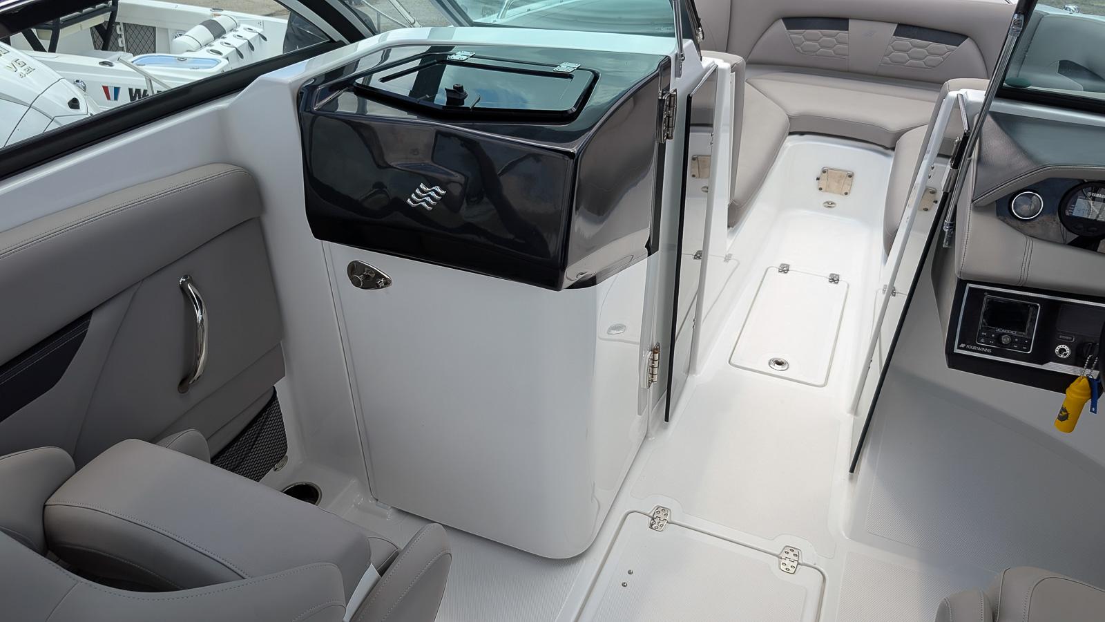 2024 Four Winns HD8 OB boat interior with seating and control panel.