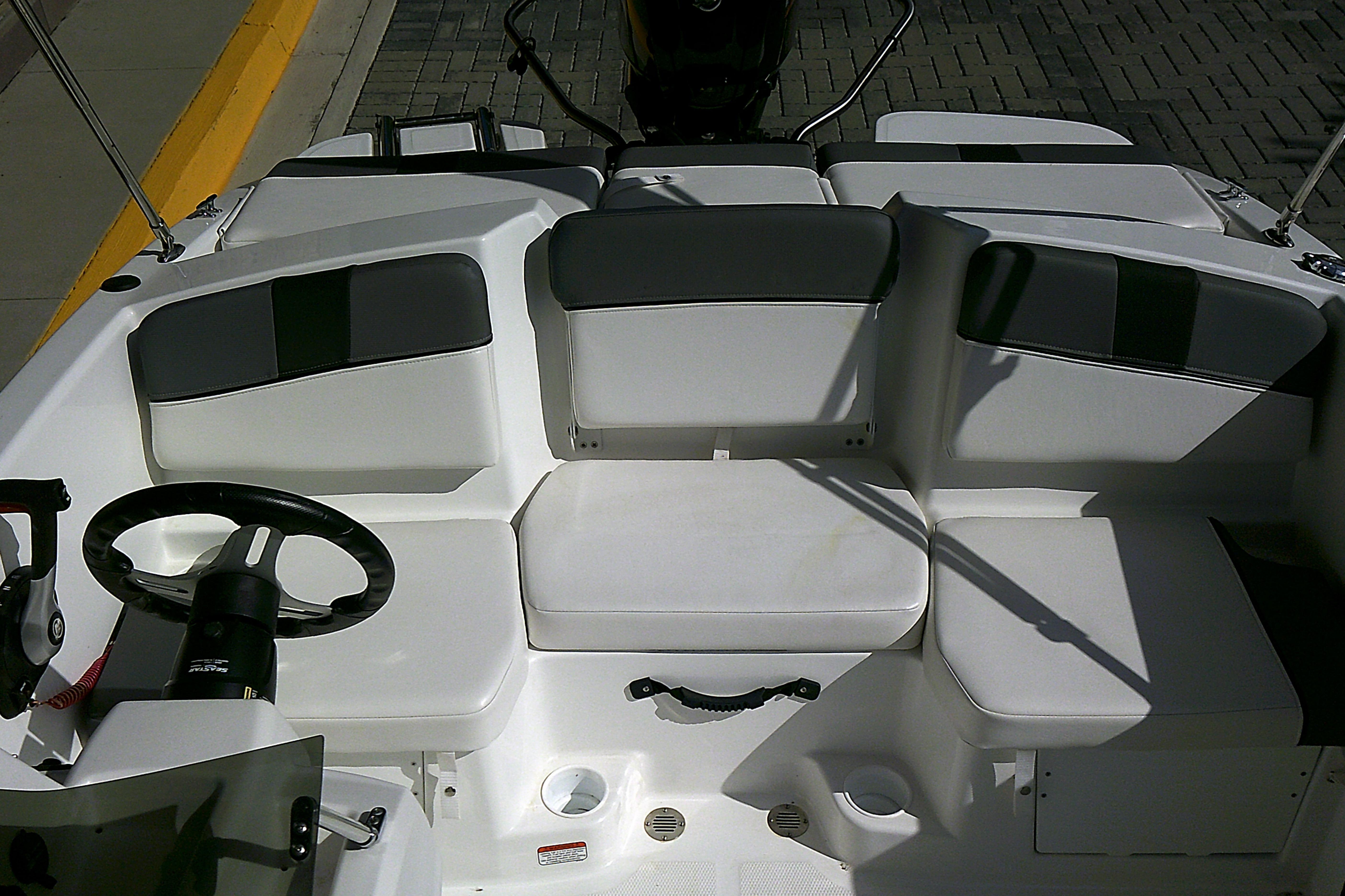 2025 Tahoe T16 boat interior with white seating and steering wheel.