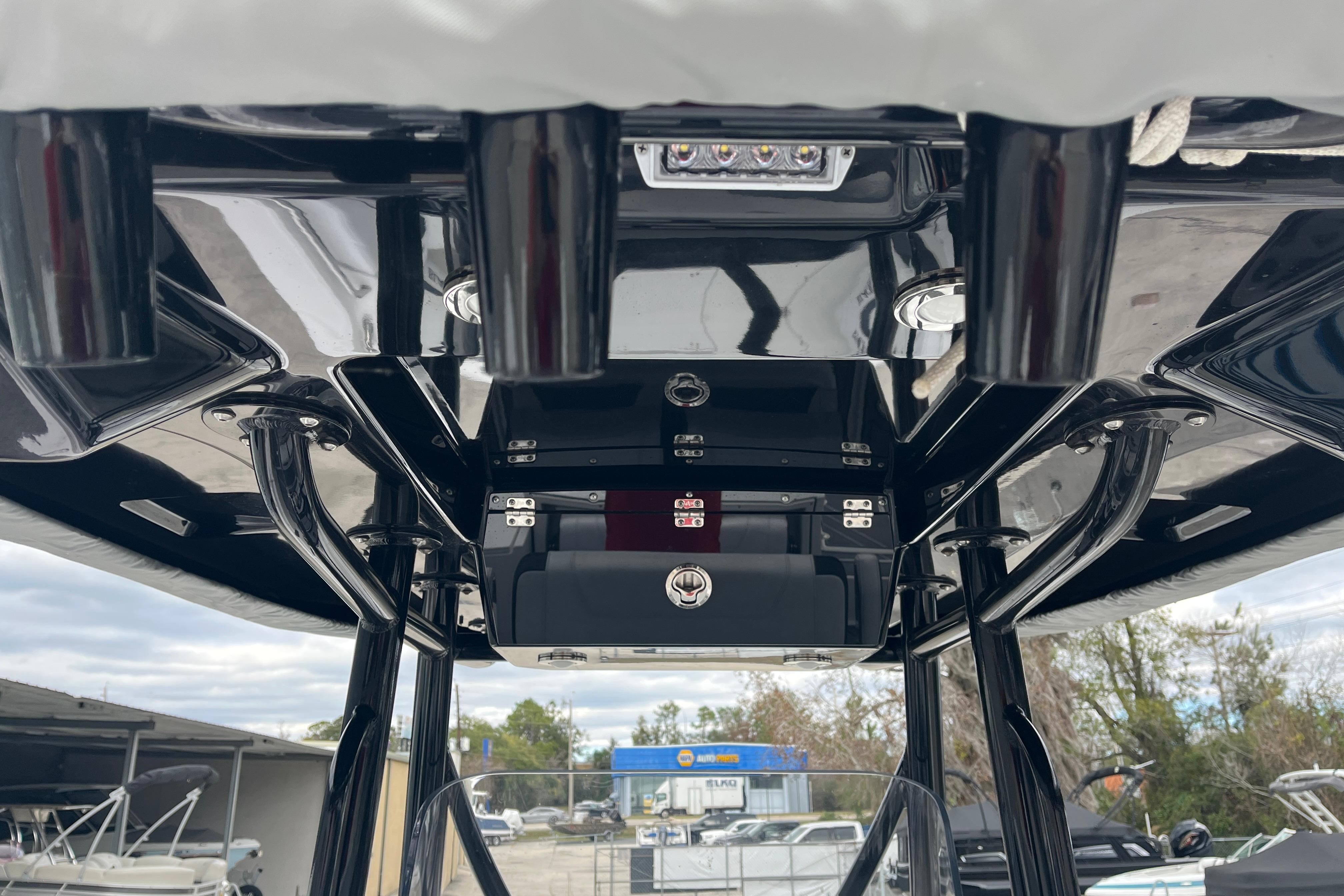 2021 Blackfin 252 CC boat console with sleek black finish and overhead storage.