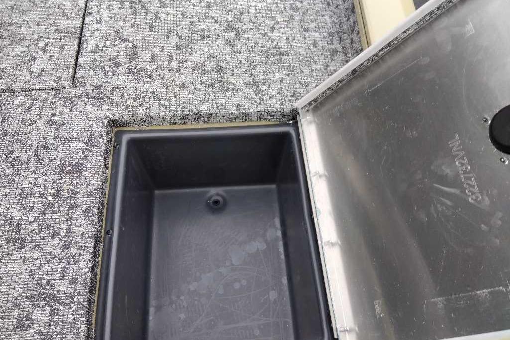 Open storage compartment on 2026 Tracker Pro Team 195 boat with textured flooring.
