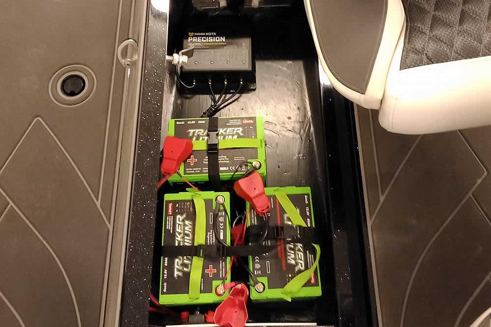 2026 Ranger 620xFS Pro boat battery compartment with Tracker lithium batteries and Minn Kota Precision charger.