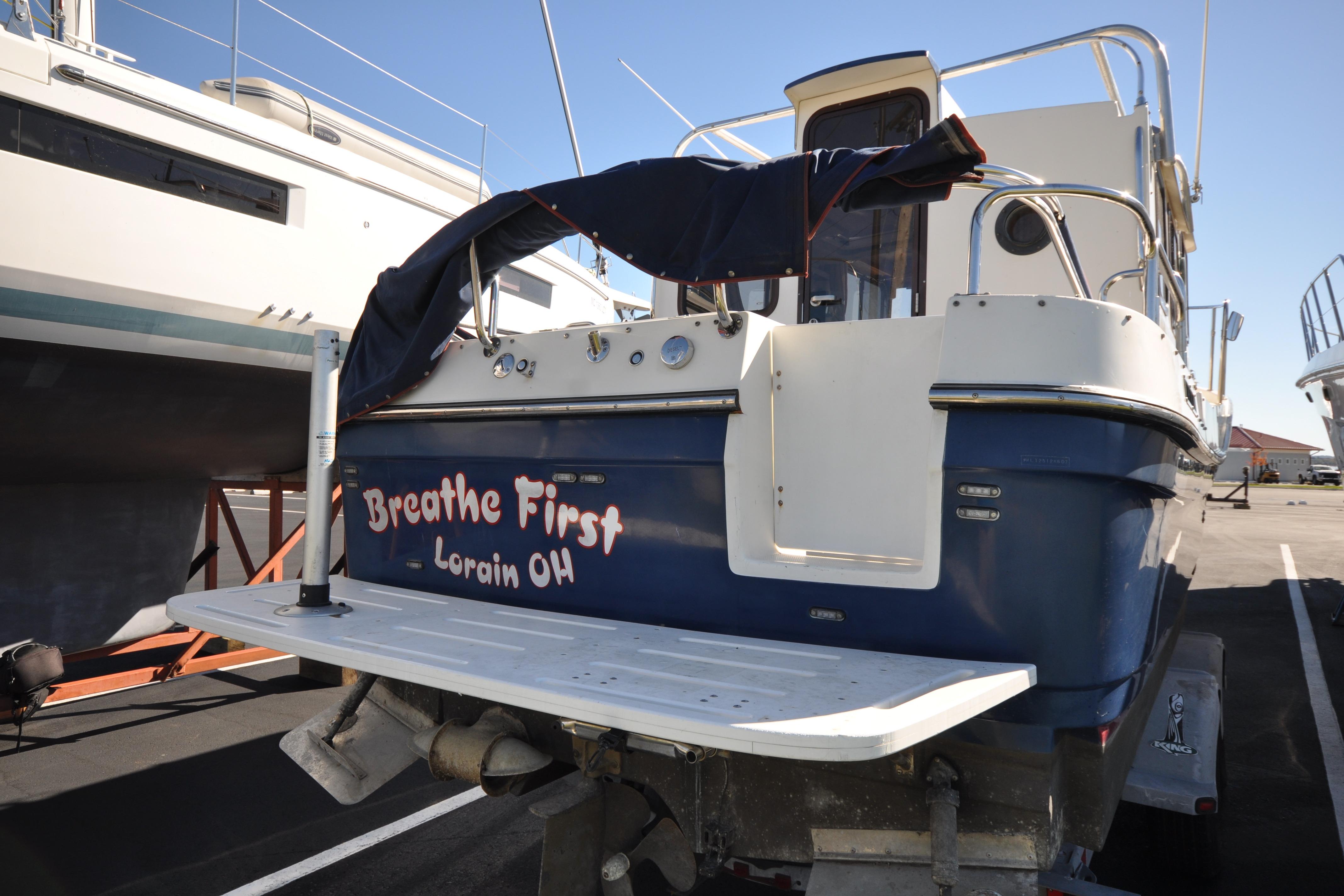 2007 Ranger Tug R-25 boat named "Breathe First" in Lorain, Ohio, docked outdoors.