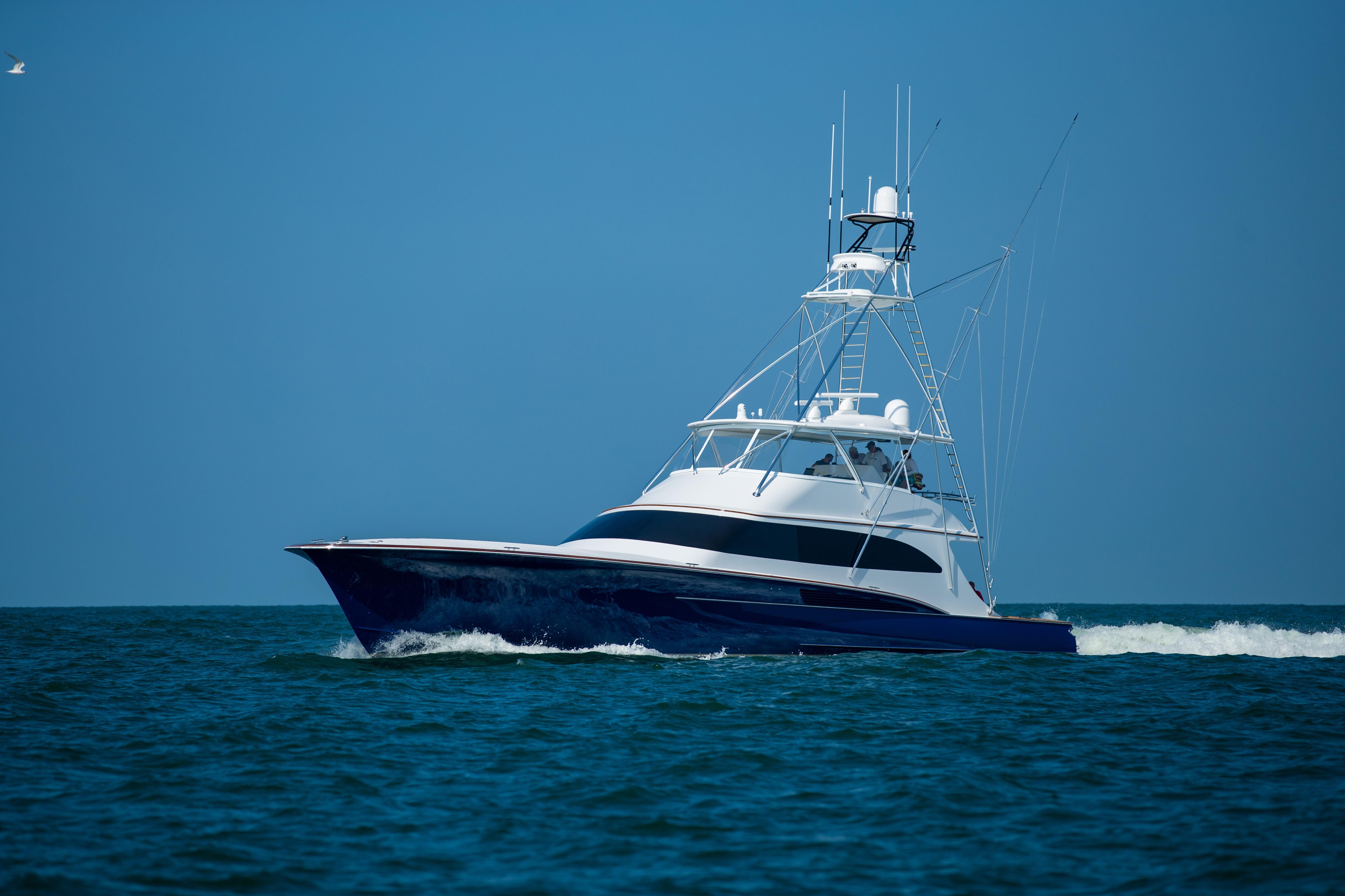 2020 Jarrett Bay 84 yacht cruising on open sea under clear blue sky.