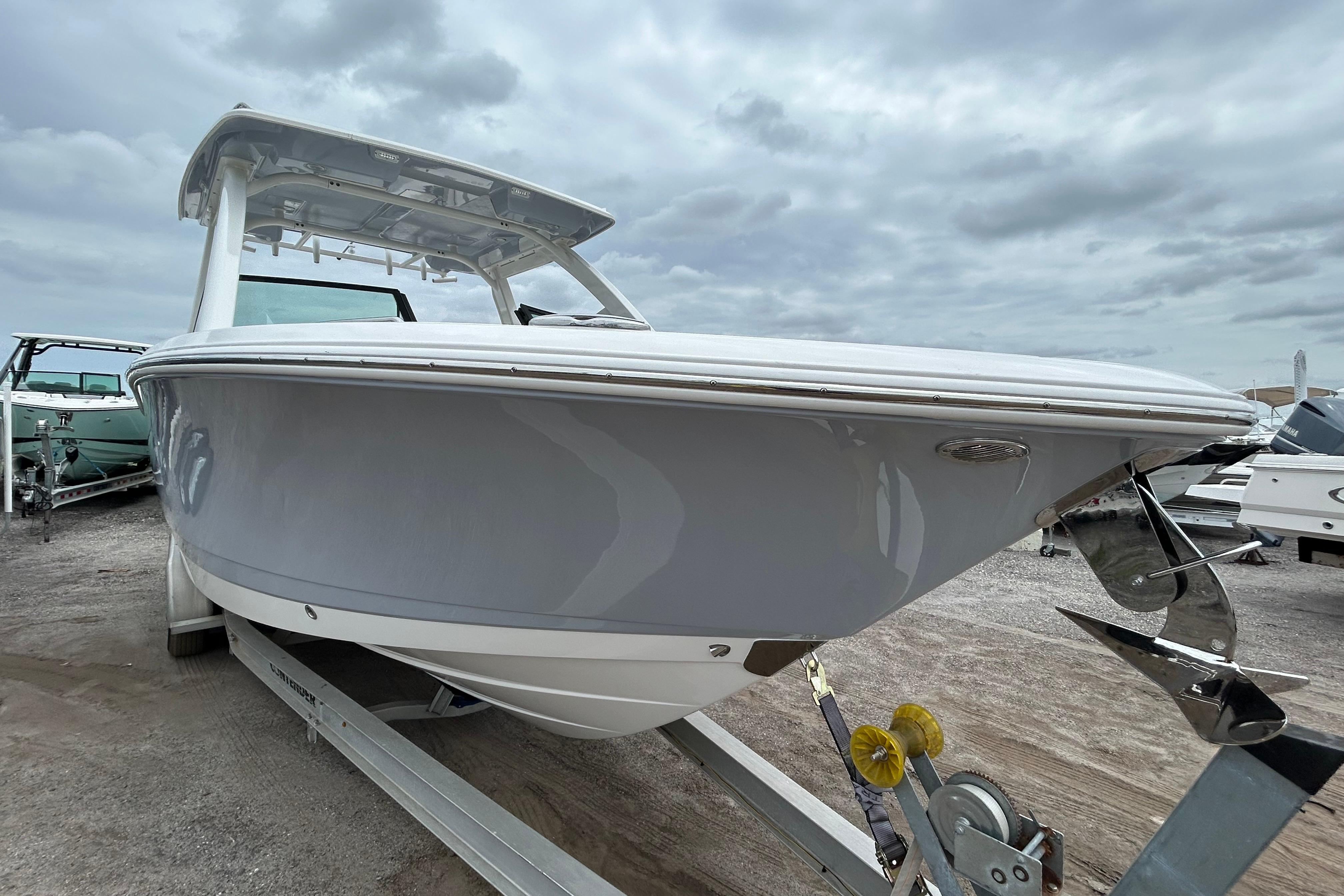 2026 Robalo R277 Dual Console boat on trailer under cloudy sky.