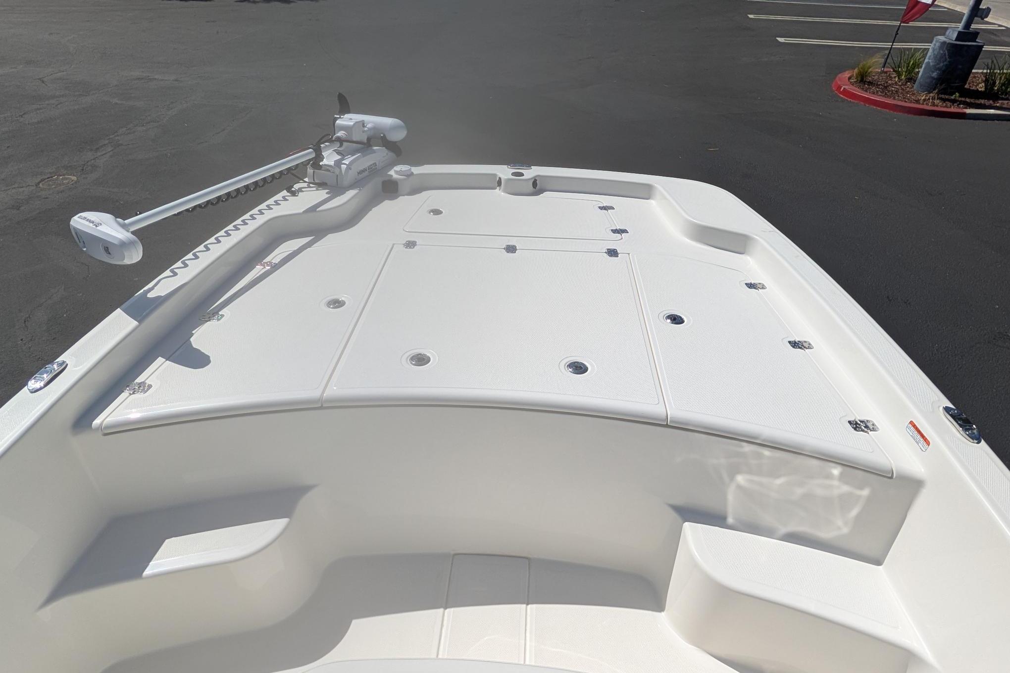 2026 Mako Pro Skiff 19 CC boat deck with trolling motor in parking lot.