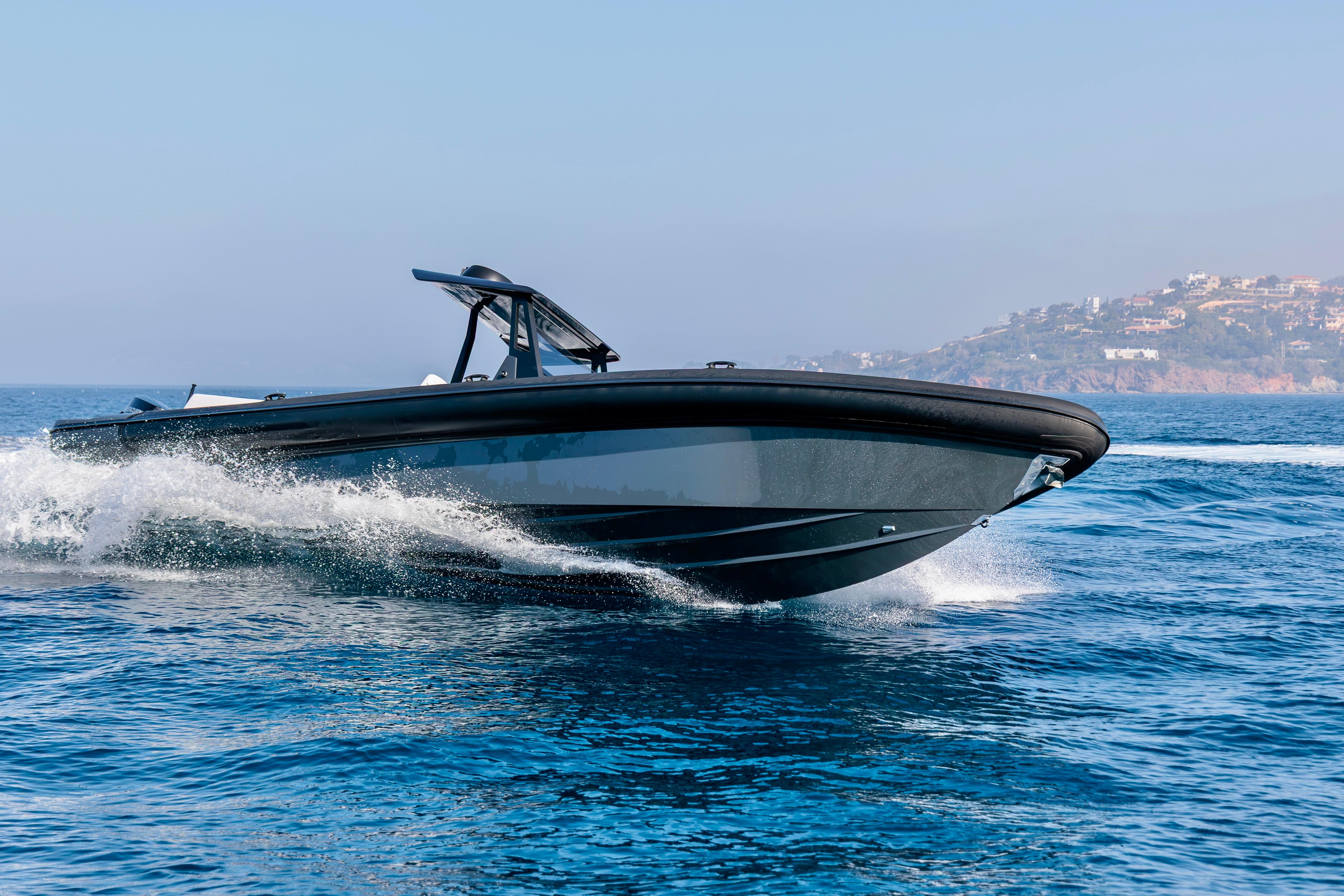 2026 Rock Marine RM 36 boat cruising on open water, coastal background.