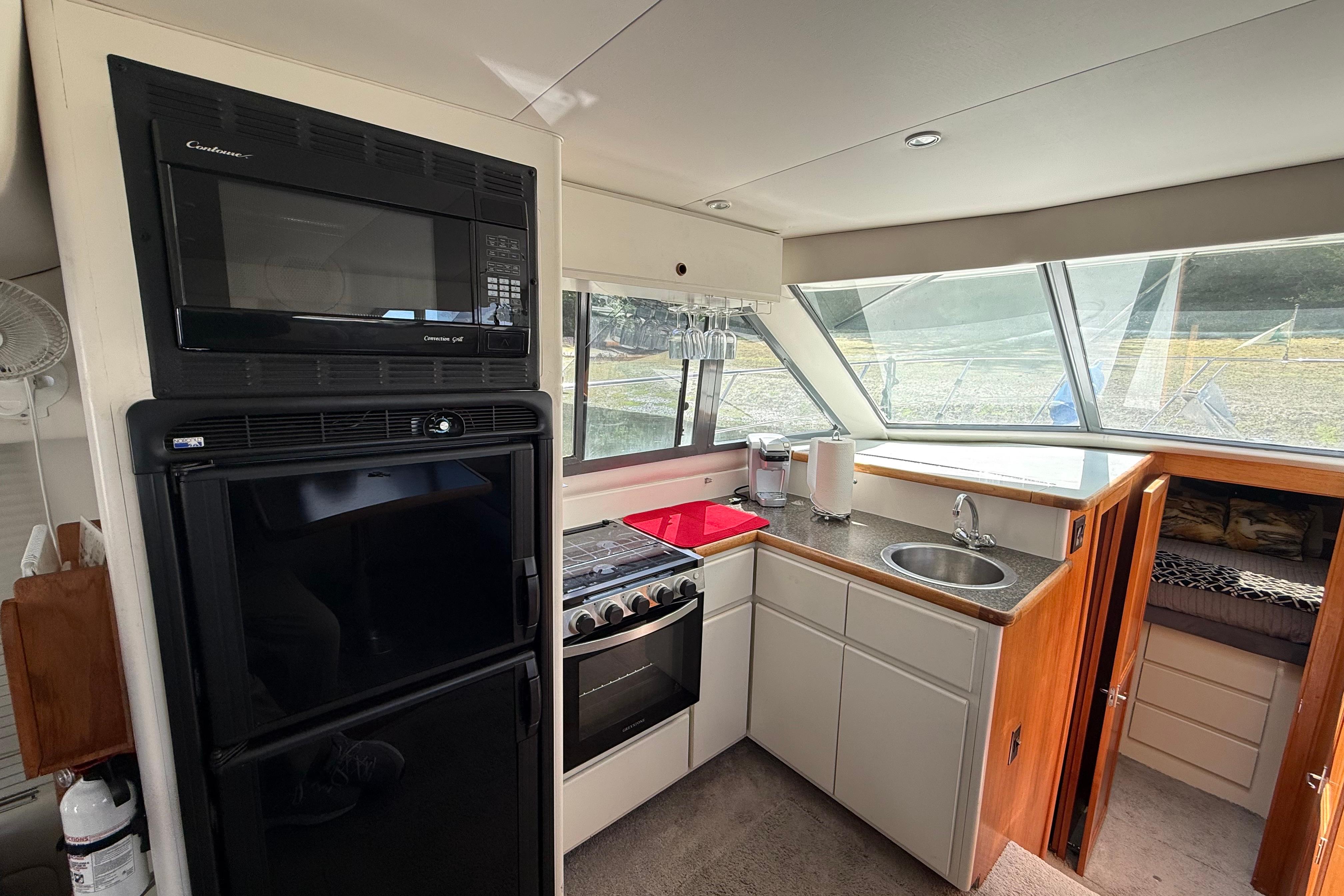 Interior of 1995 Carver 370 Voyager yacht kitchen with appliances and sink.