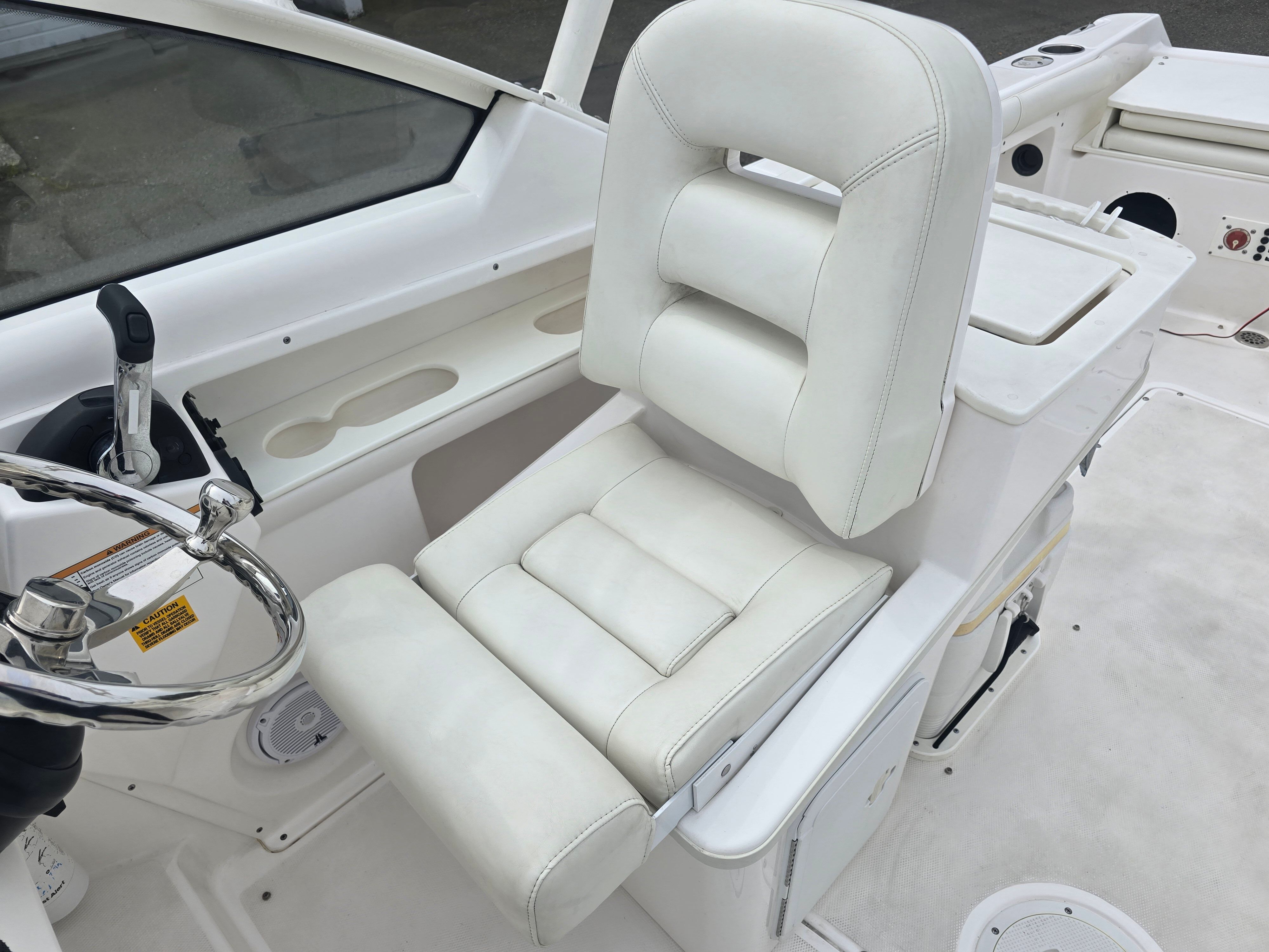 Interior view of a 2017 Everglades 230 Dual Console boat with a white seat.