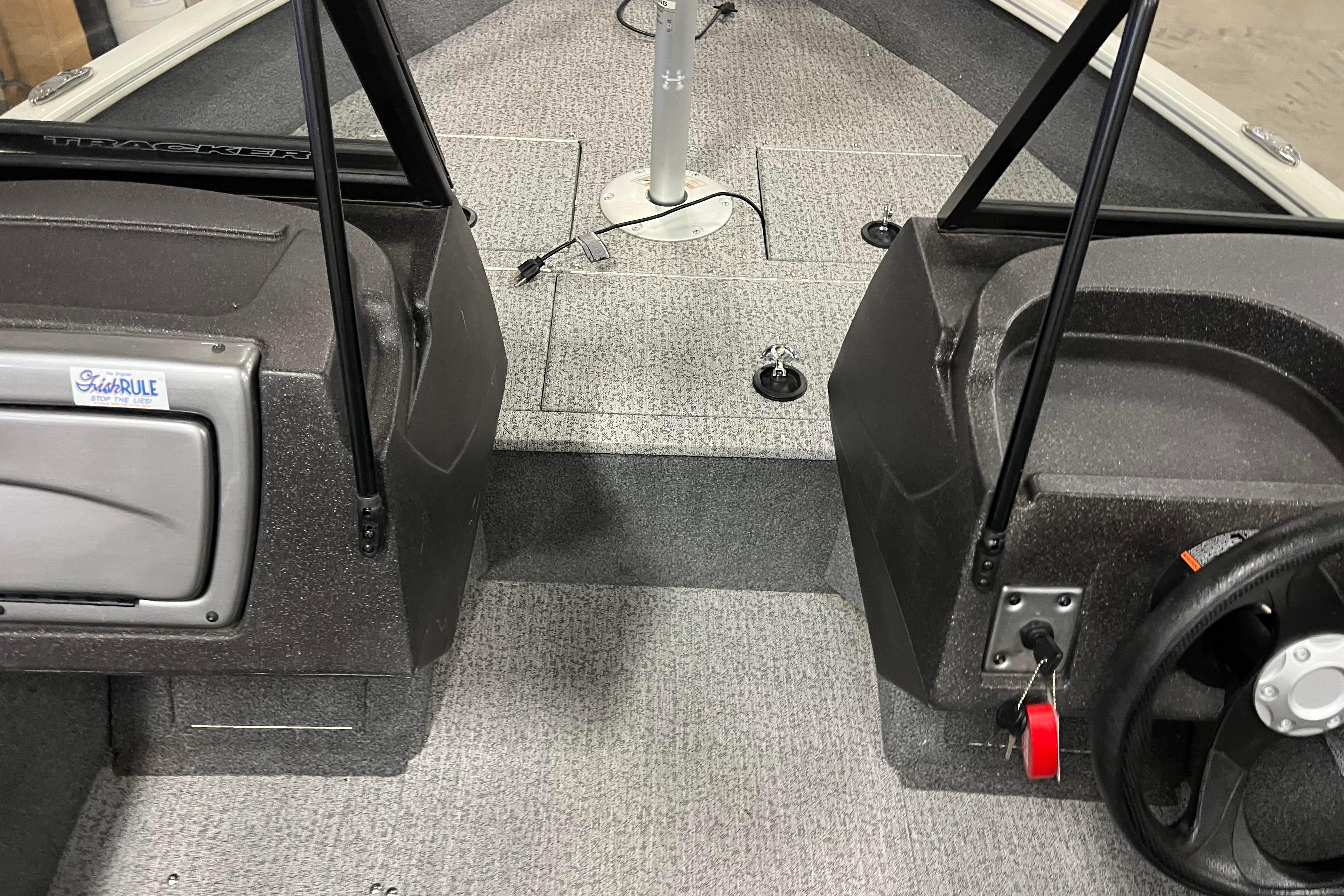 2022 Tracker Pro Guide V-16 WT boat interior with steering wheel and carpeted floor.