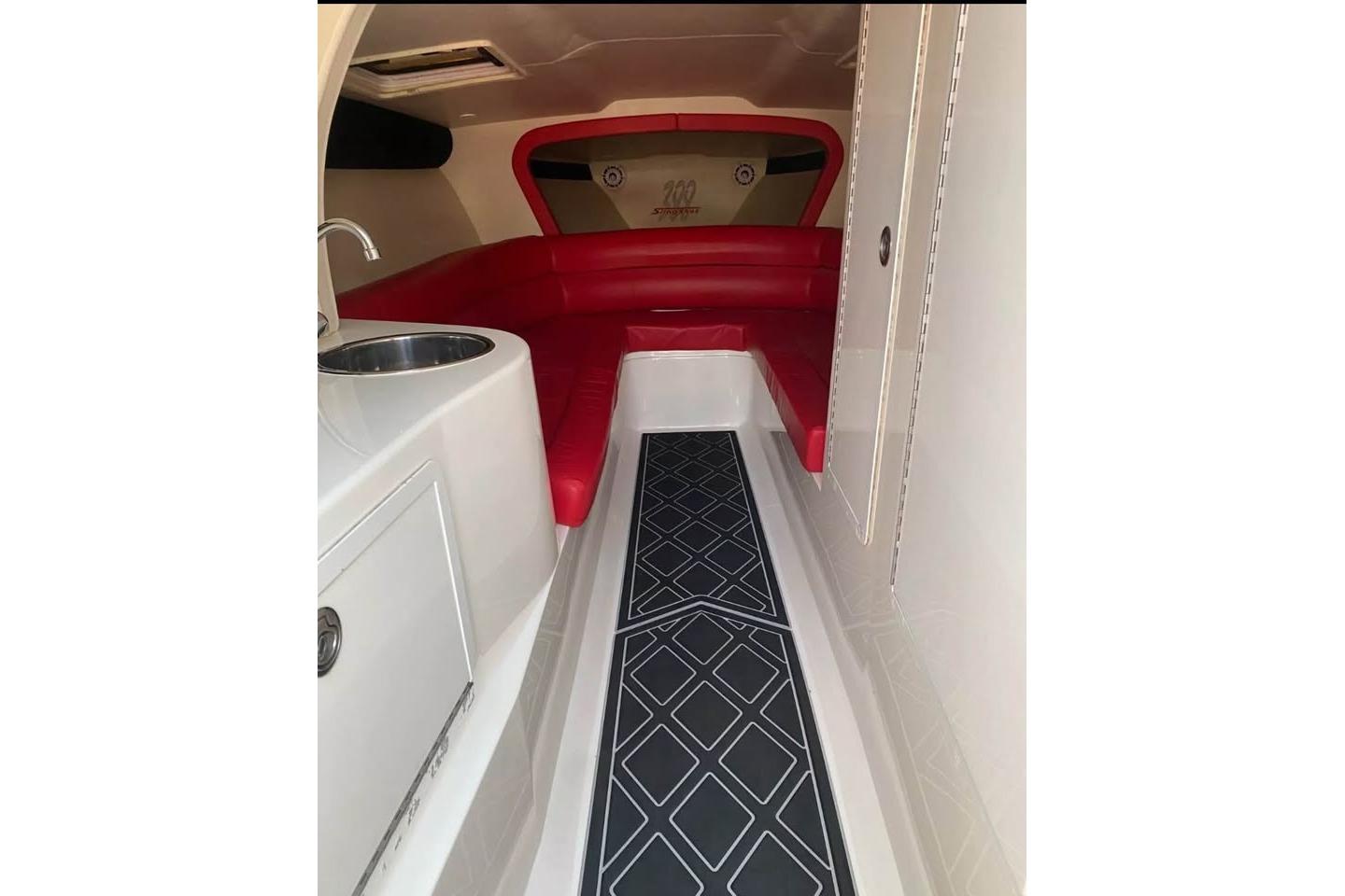 Interior of 2005 Hustler 388 SLINGSHOT with red seating and modern amenities.