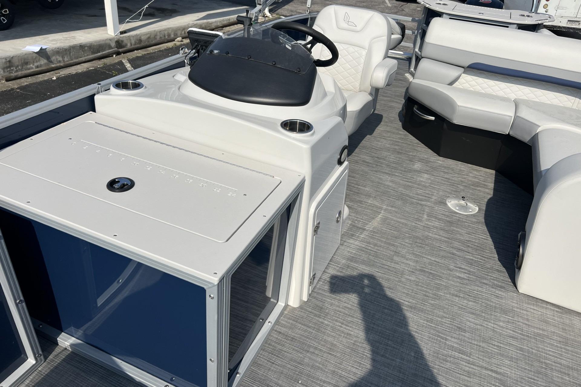 2024 Lowe SF 214 Sport Fish boat interior with steering console and seating area.
