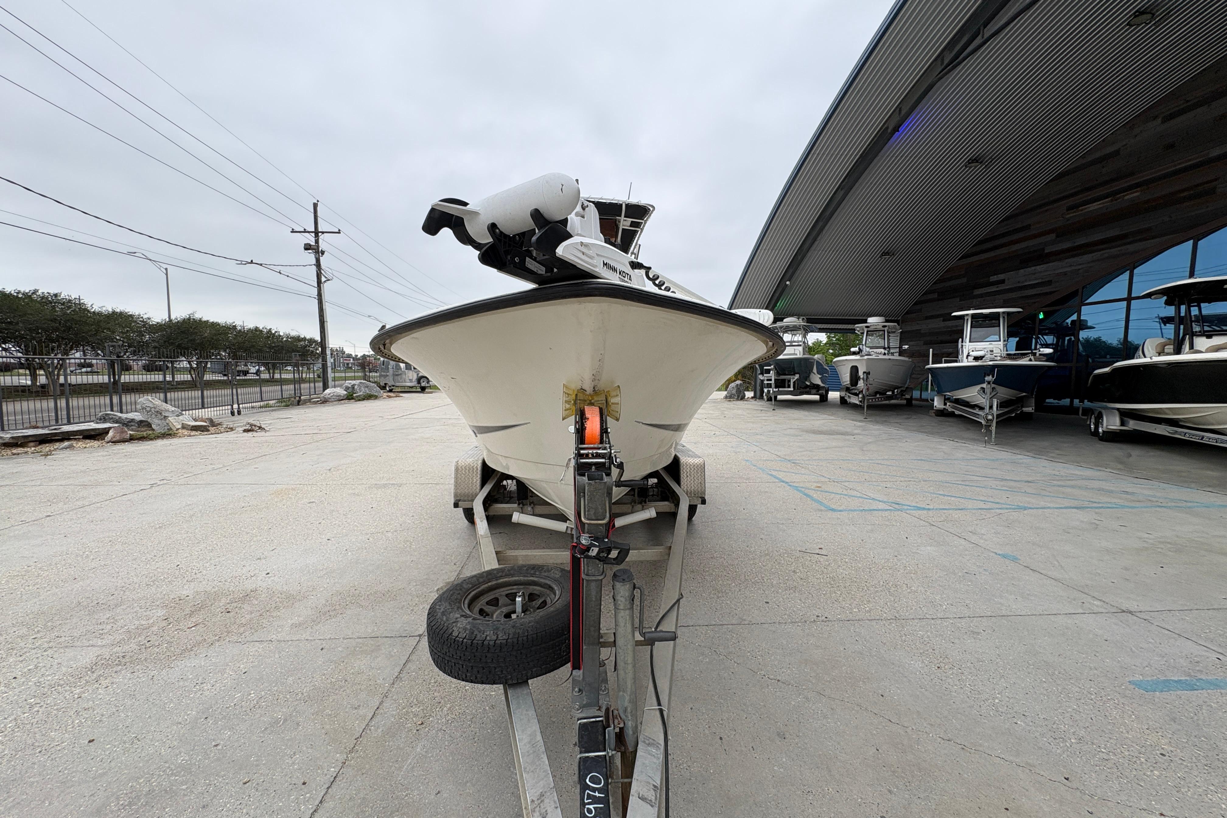 1998 Hydra-Sports 22 Ocean CC boat on trailer outside a showroom.